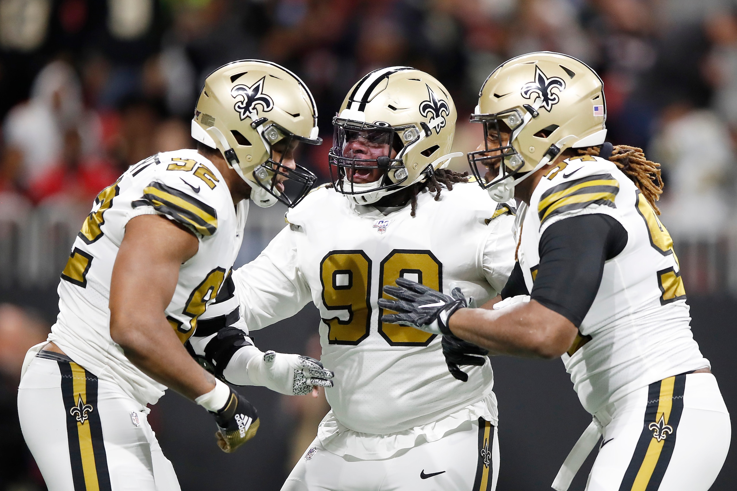 ATLANTA, GEORGIA - NOVEMBER 28:  Ra'Shede Hageman #90 and Cameron Jordan #94 of the New Orleans Saints celebrate a sack by Marcus Davenport #92 against the Atlanta Falcons during the first quarter at Mercedes-Benz Stadium on November 28, 2019 in Atlanta, 