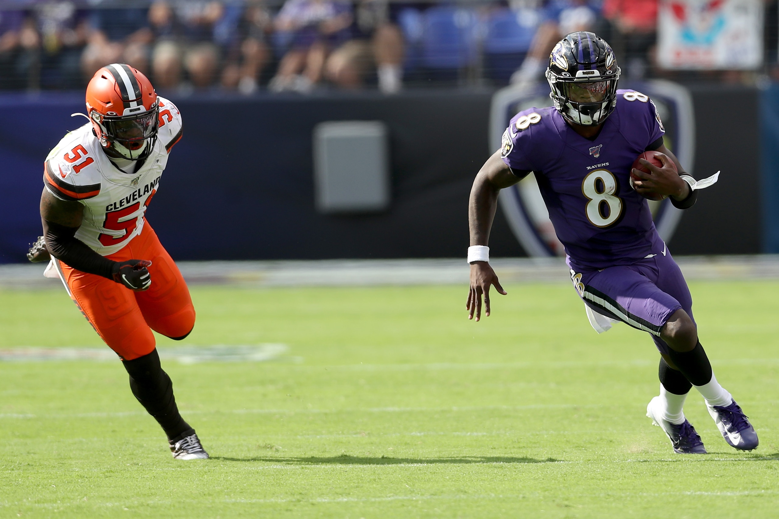 BALTIMORE, MARYLAND - SEPTEMBER 29: Quarterback Lamar Jackson #8 of the Baltimore Ravens eludes the tackle of Mack Wilson #51 of the Cleveland Browns at M&T Bank Stadium on September 29, 2019 in Baltimore, Maryland. (Photo by Rob Carr/Getty Images)