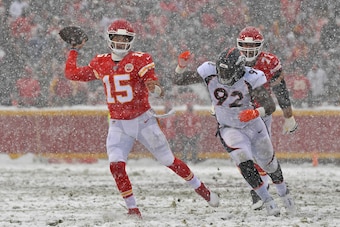KANSAS CITY, MO - DECEMBER 15:  Quarterback Patrick Mahomes #15 of the Kansas City Chiefs throws a pass against pressure from defensive end Jonathan Harris #92 of the Denver Broncos during the second half  at Arrowhead Stadium on December 15, 2019 in Kans