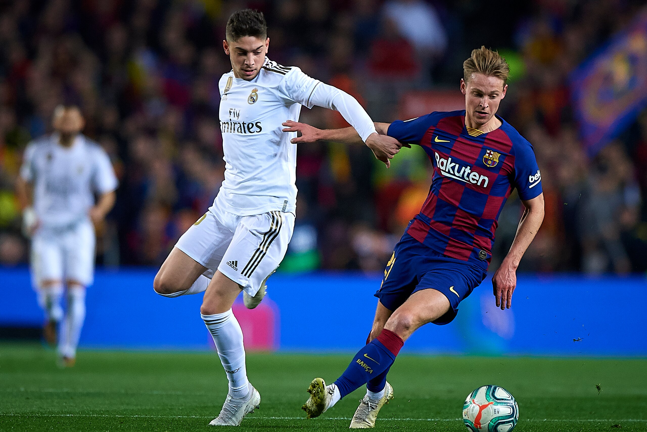 BARCELONA, SPAIN - DECEMBER 18: Frankie de Jong (R) of Barcelona competes for the ball with Federico Santiago Valverde of Real Madrid during the Liga match between FC Barcelona and Real Madrid CF at Camp Nou on December 18, 2019 in Barcelona, Spain. (Phot