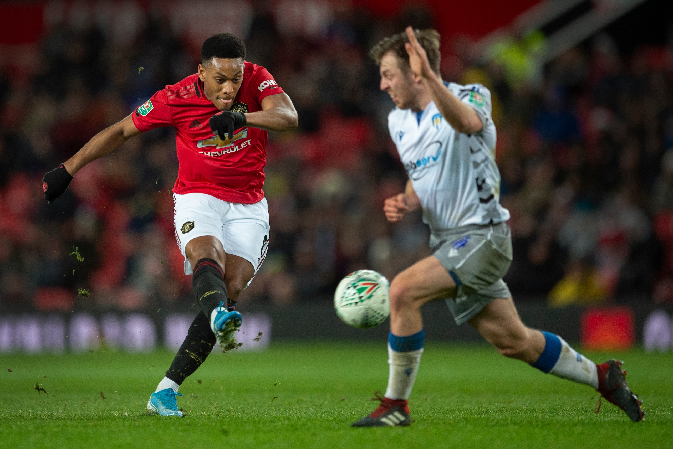 MANCHESTER, ENGLAND - DECEMBER 18: Anthony Martial of Manchester United tries to shoot past Tom Lapslie of Colchester United during the Carabao Cup Quarter Final match between Manchester United and Colchester United at Old Trafford on December 18, 2019 in
