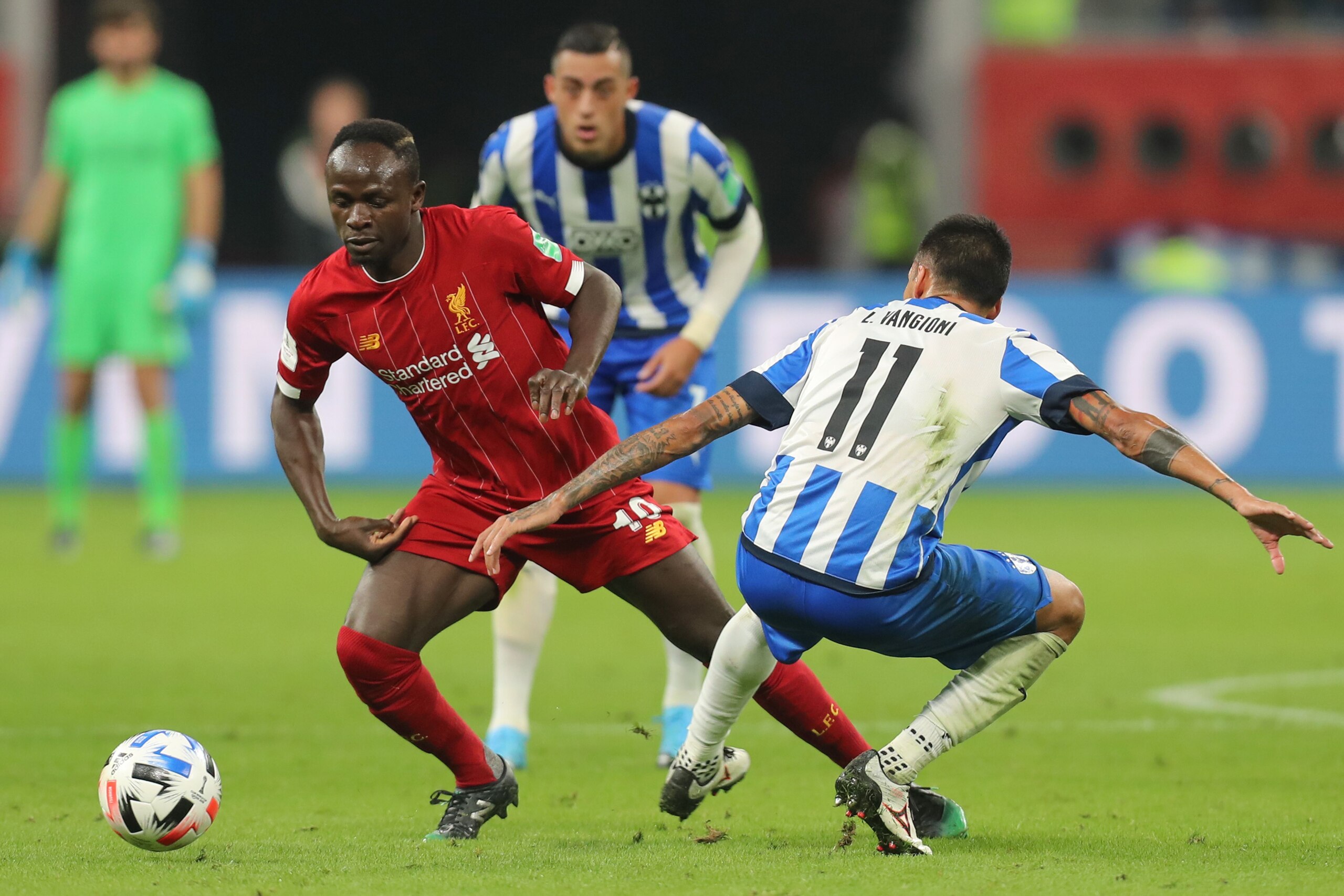 Liverpool's Senegalese striker Sadio Mane (L) dribbles past Monterrey's defender Leonel Vangioni during the 2019 FIFA Club World Cup semi-final football match between Mexico's Monterrey and England's Liverpool at the Khalifa International Stadium in the Q