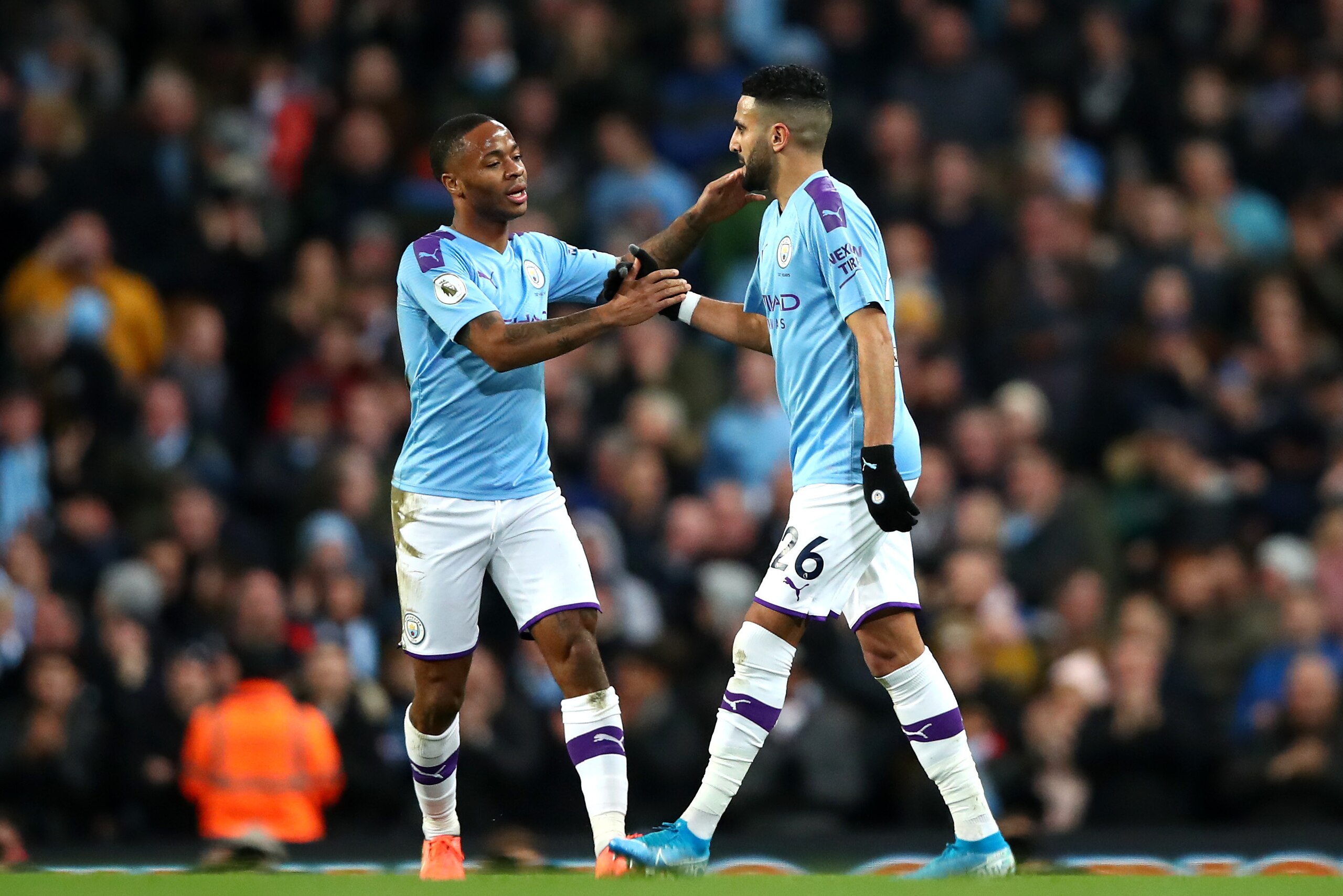 MANCHESTER, ENGLAND - DECEMBER 21: Riyad Mahrez of Manchester City celebrates after scoring his team's first goal with teammate Raheem Sterling during the Premier League match between Manchester City and Leicester City at Etihad Stadium on December 21, 20