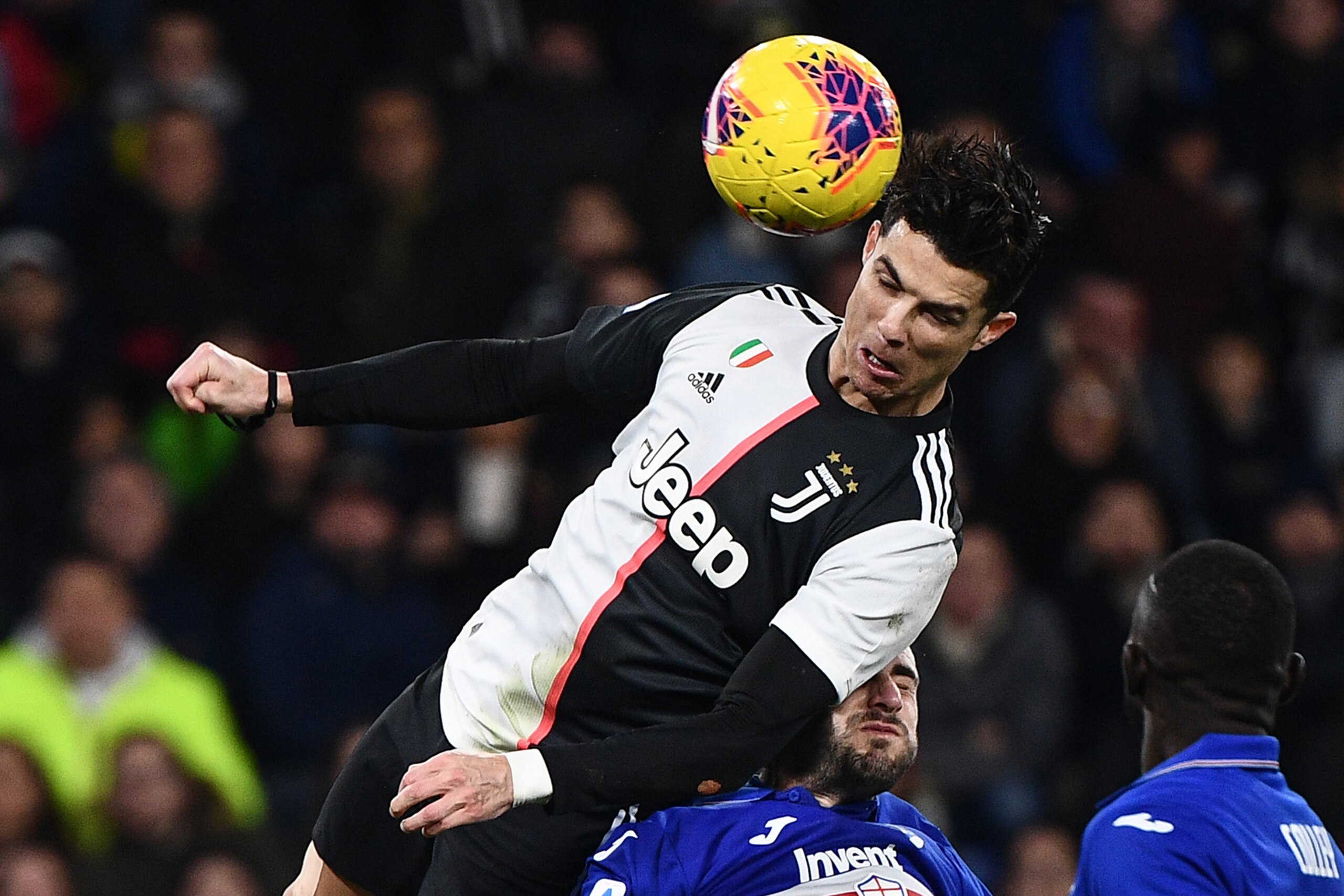 Juventus' Portuguese forward Cristiano Ronaldo scores a header during the Italian Serie A football match Sampdoria vs Juventus on December 18, 2019 at the Luigi-Ferraris stadium in Genoa. (Photo by Marco Bertorello / AFP) (Photo by MARCO BERTORELLO/AFP vi