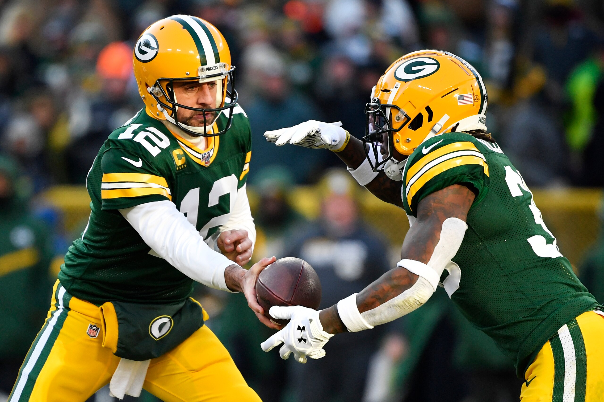 GREEN BAY, WISCONSIN - DECEMBER 15: Aaron Rodgers #12 of the Green Bay Packers hands the football off during the game against the Chicago Bears at Lambeau Field on December 15, 2019 in Green Bay, Wisconsin. (Photo by Quinn Harris/Getty Images)