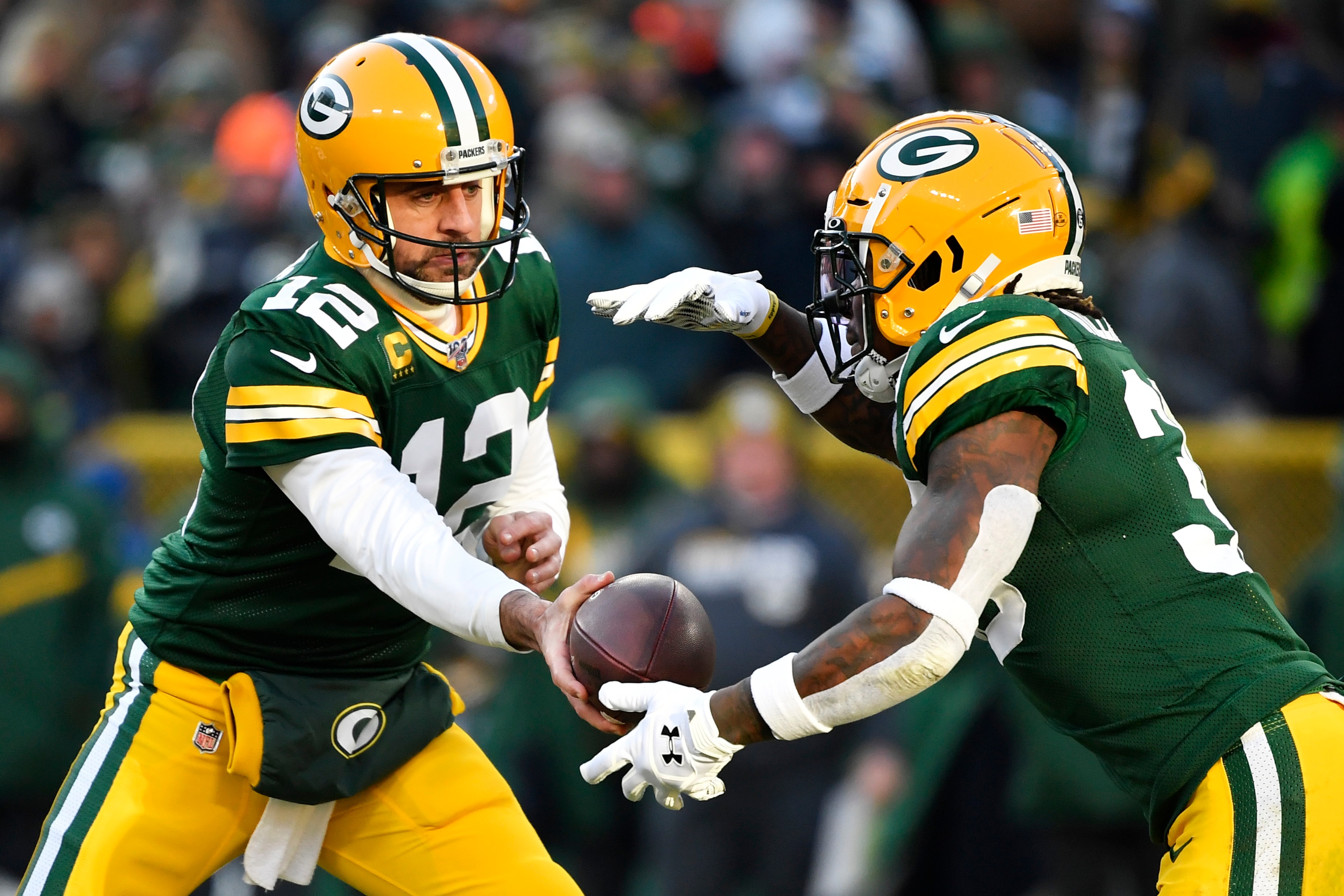GREEN BAY, WISCONSIN - DECEMBER 15: Aaron Rodgers #12 of the Green Bay Packers hands the football off during the game against the Chicago Bears at Lambeau Field on December 15, 2019 in Green Bay, Wisconsin. (Photo by Quinn Harris/Getty Images)