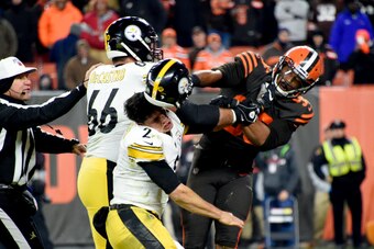 CLEVELAND, OHIO - NOVEMBER 14: Quarterback Mason Rudolph #2 of the Pittsburgh Steelers fights with defensive end Myles Garrett #95 of the Cleveland Browns during the second half at FirstEnergy Stadium on November 14, 2019 in Cleveland, Ohio. The Browns de