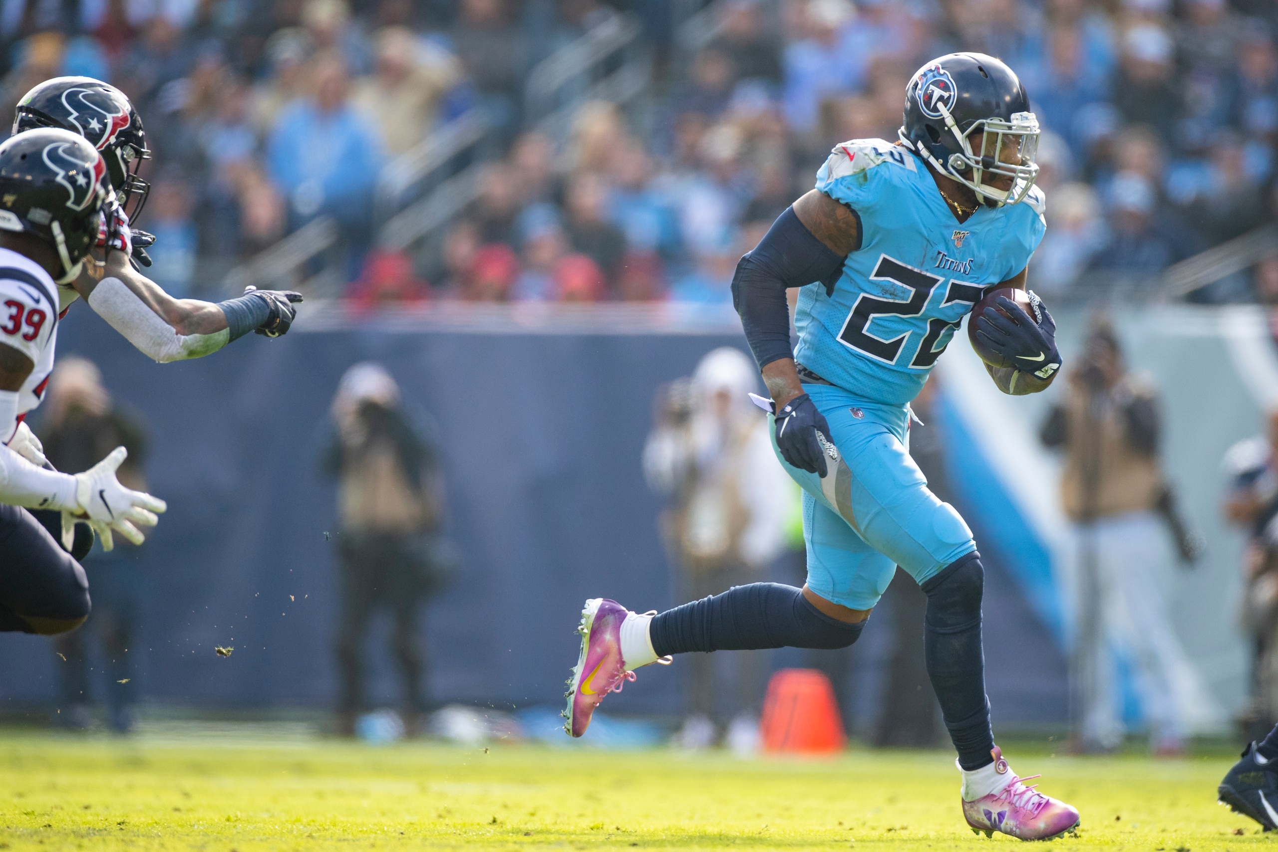 NASHVILLE, TN - DECEMBER 15:  Derrick Henry #22 of the Tennessee Titans carries the ball against the Houston Texans during the second quarter at Nissan Stadium on December 15, 2019 in Nashville, Tennessee. Houston defeats Tennessee 24-21.  (Photo by Brett