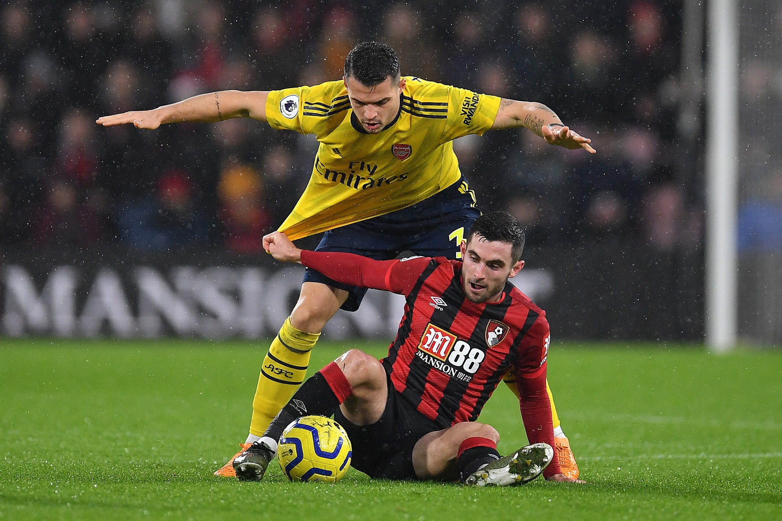 BOURNEMOUTH, ENGLAND - DECEMBER 26: Lewis Cook of AFC Bournemouth battles for possession with Granit Xhaka of Arsenal during the Premier League match between AFC Bournemouth and Arsenal FC at Vitality Stadium on December 26, 2019 in Bournemouth, United Ki