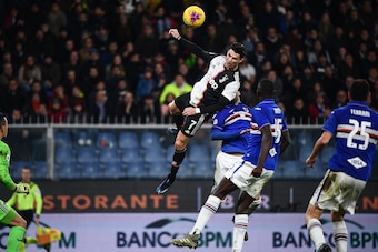 TOPSHOT - Juventus' Portuguese forward Cristiano Ronaldo (C) scores a header during the Italian Serie A football match Sampdoria vs Juventus on December 18, 2019 at the Luigi-Ferraris stadium in Genoa. (Photo by Marco Bertorello / AFP) (Photo by MARCO BER