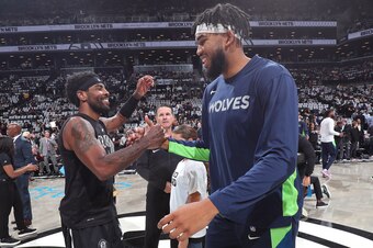 BROOKLYN, NY - OCTOBER 23: Kyrie Irving #11 of the Brooklyn Nets and Karl-Anthony Towns #32 of the Minnesota Timberwolves shake hands before the game on October 23, 2019 at Barclays Center in Brooklyn, New York. NOTE TO USER: User expressly acknowledges a