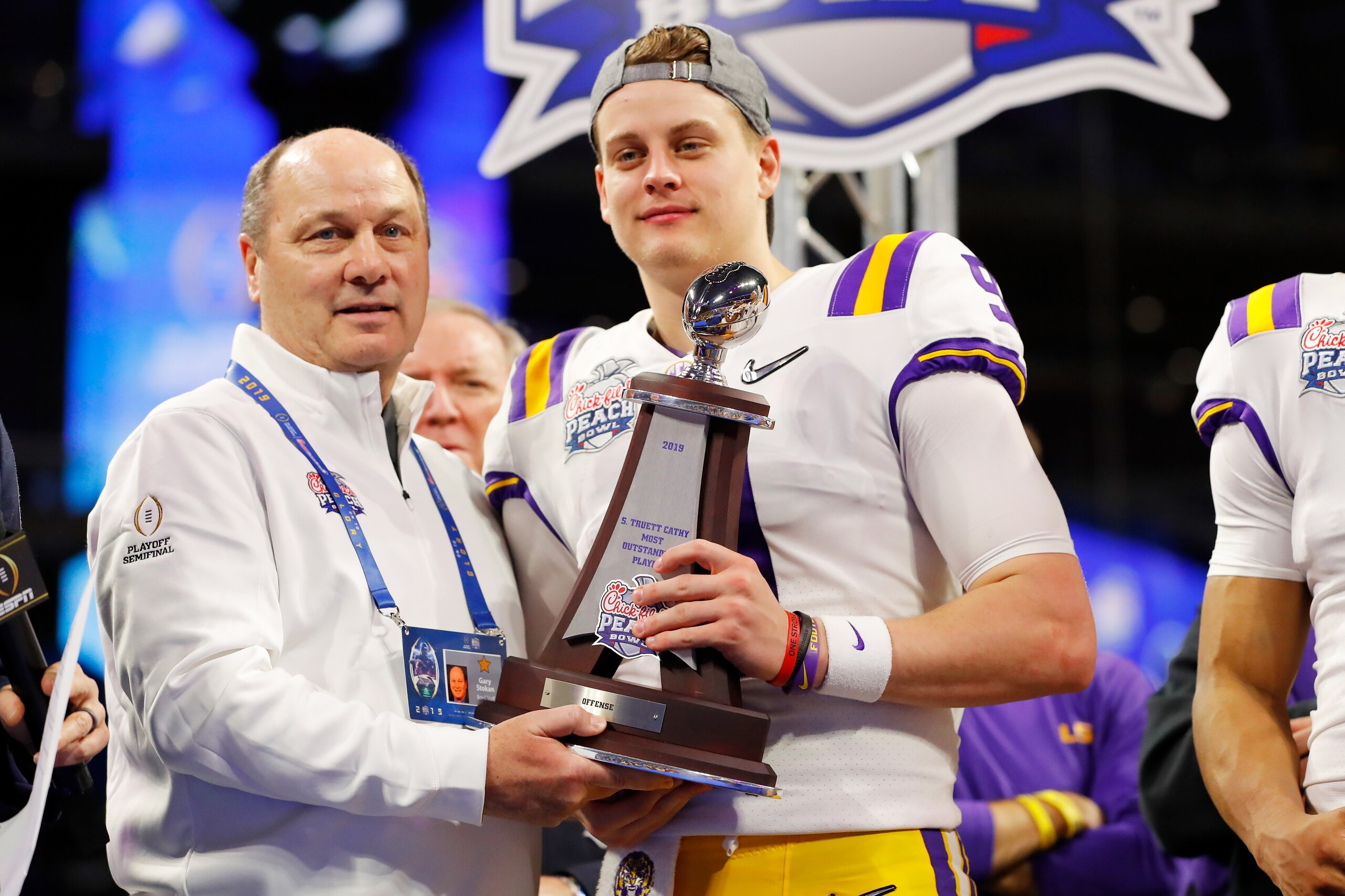 ATLANTA, GEORGIA - DECEMBER 28: Quarterback Joe Burrow #9 of the LSU Tigers receives the S. Truett Cathy Most Outstanding Player trophy after winning the Chick-fil-A Peach Bowl 28-63 over the Oklahoma Sooners at Mercedes-Benz Stadium on December 28, 2019 