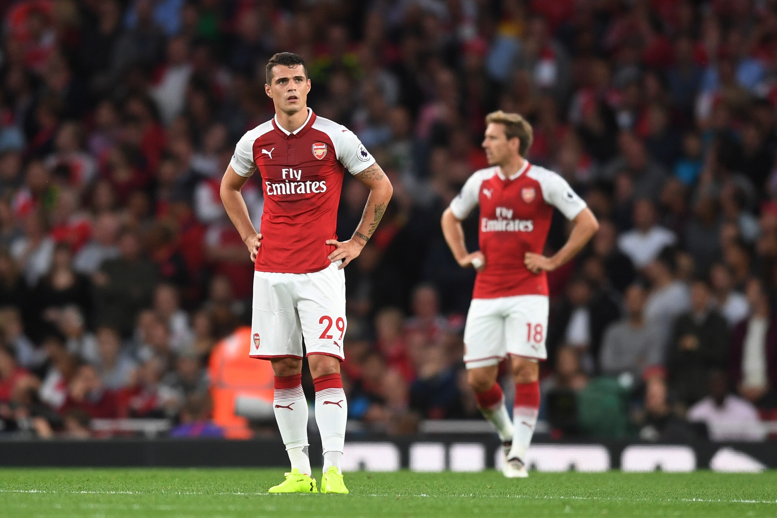 LONDON, ENGLAND - AUGUST 11:  (L-R) Granit Xhaka and Nacho Monreal of Arsenal look on after conceding a second first half goal during the Premier League match between Arsenal and Leicester City at the Emirates Stadium on August 11, 2017 in London, England