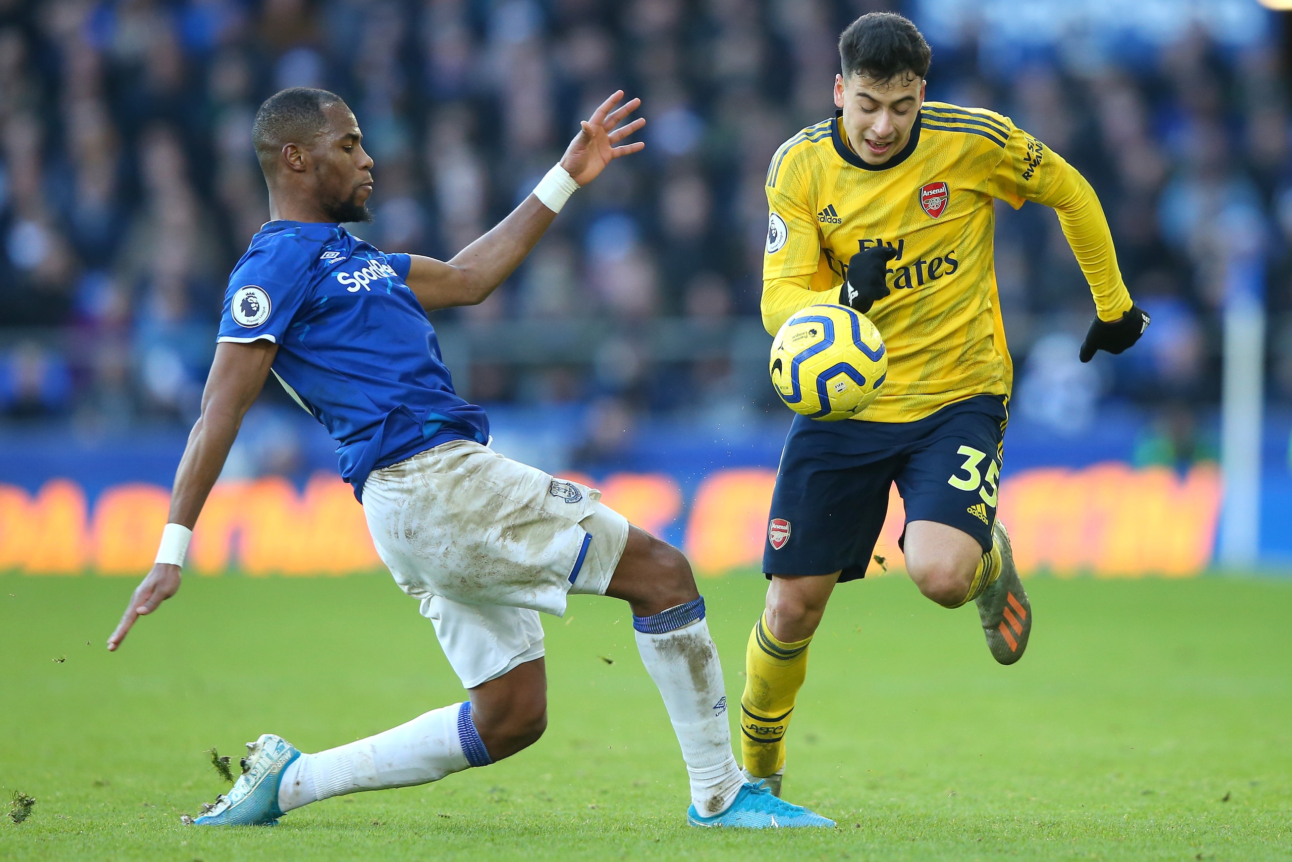 LIVERPOOL, ENGLAND - DECEMBER 21: Djibril Sidibe of Everton tackles Gabriel Martinelli of Arsenal  during the Premier League match between Everton FC and Arsenal FC at Goodison Park on December 21, 2019 in Liverpool, United Kingdom. (Photo by Alex Livesey