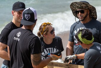 Nelson Cruz (far right), who was one of about 70 major league players and volunteers who met to help clean a beach in Santo Domingo, said that educating people how to properly dispose of waste is as important as getting rid of the waste itself.