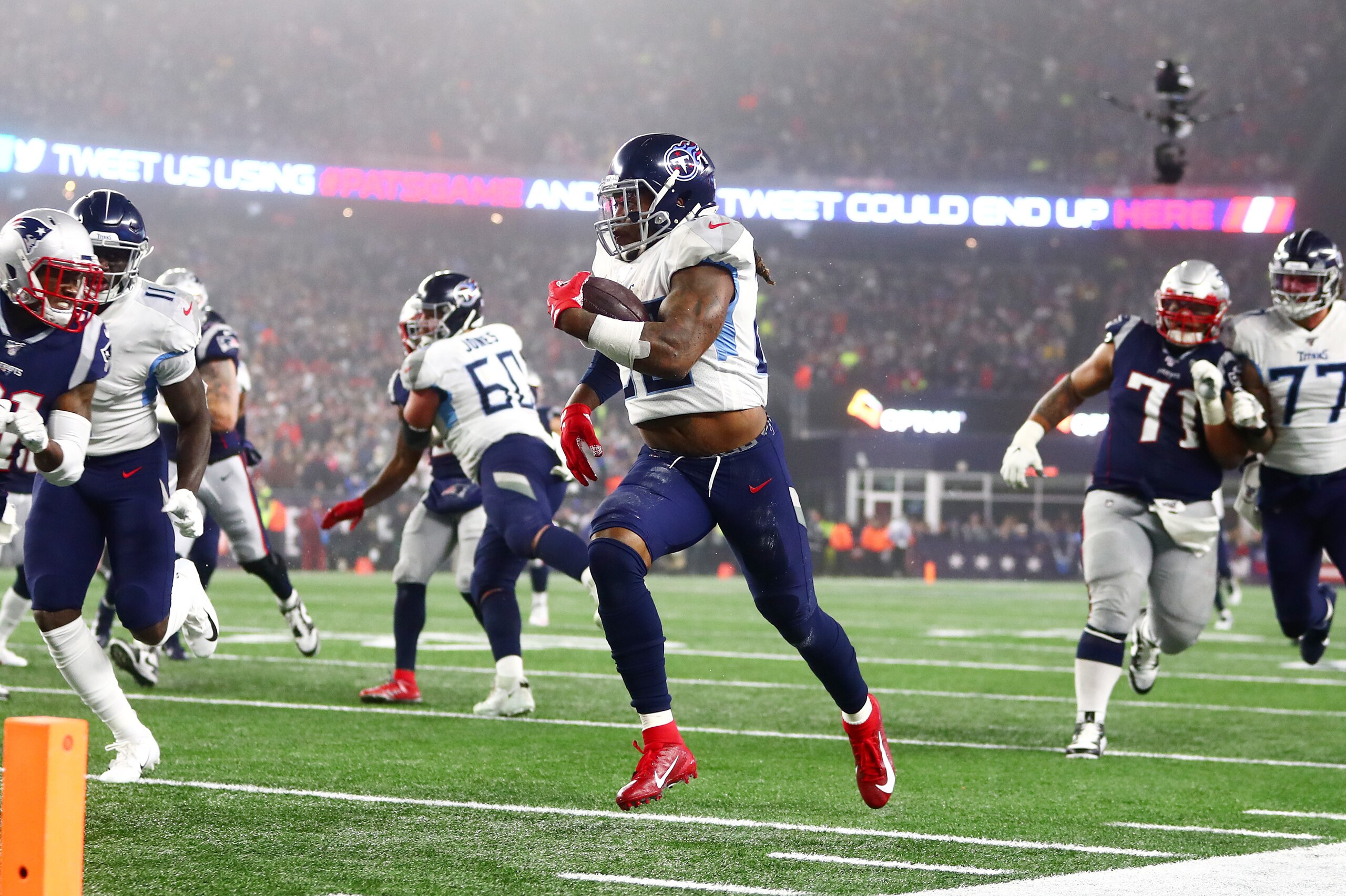 FOXBOROUGH, MASSACHUSETTS - JANUARY 04: Derrick Henry #22 of the Tennessee Titans carries the ball against the New England Patriots in the second quarter of the AFC Wild Card Playoff game at Gillette Stadium on January 04, 2020 in Foxborough, Massachusett