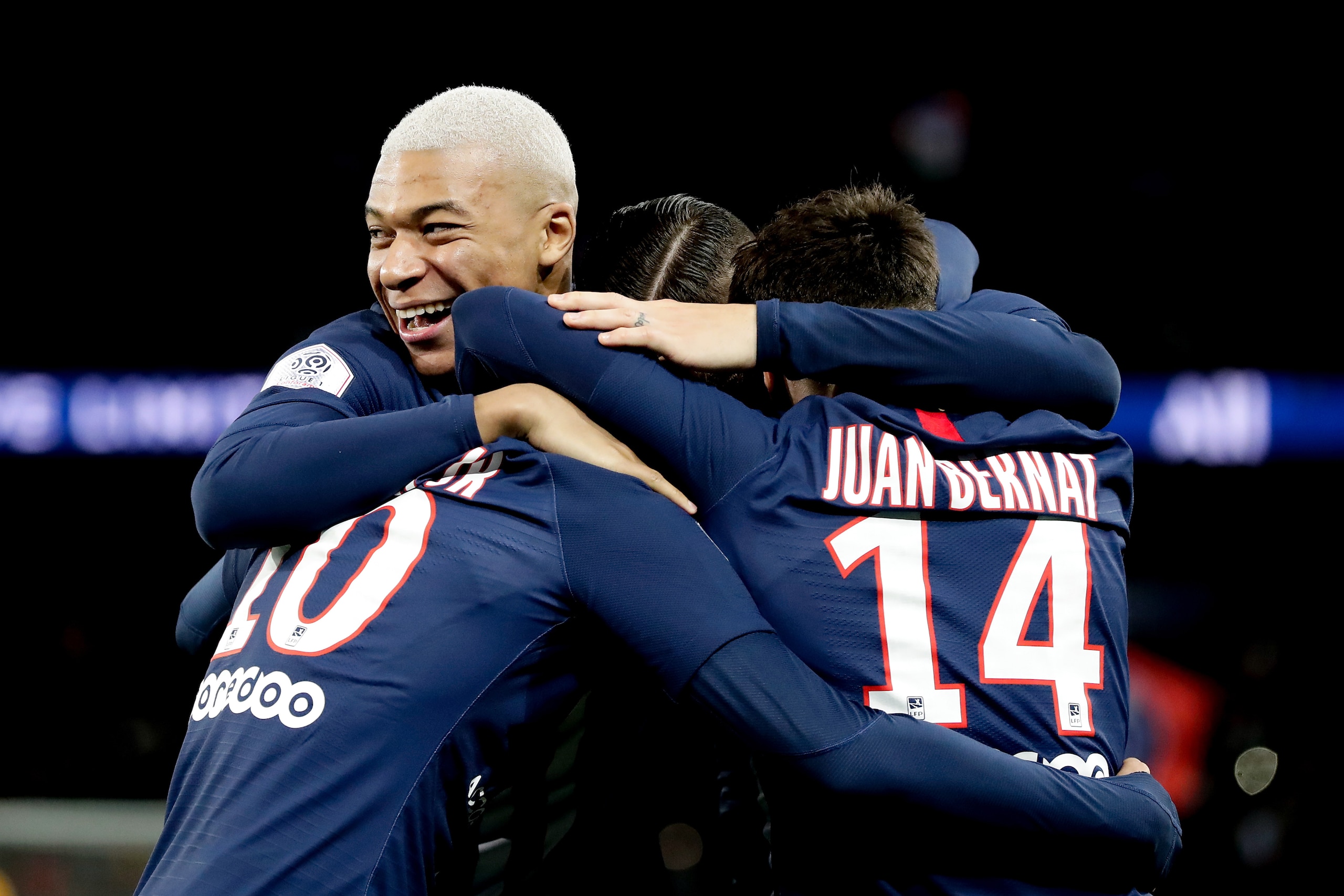PARIS, FRANCE - DECEMBER 21: (L-R) Kylian Mbappe of Paris Saint Germain, Neymar Jr of Paris Saint Germain, Juan Bernat of Paris Saint Germain celebrate  during the French League 1  match between Paris Saint Germain v Amiens SC at the Parc des Princes on D