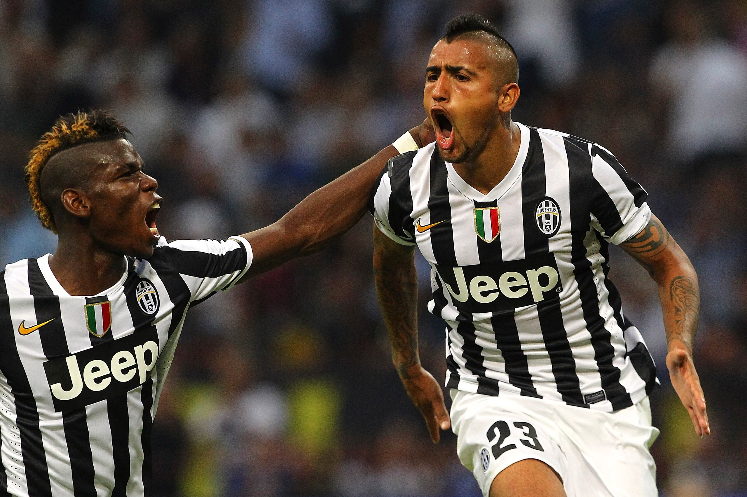 MILAN, ITALY - SEPTEMBER 14:  Arturo Vidal (R) of Juventus FC celebrates his goal with team-mate Paul Pogba (L) during the Serie A match between FC Internazionale Milano and Juventus FC at San Siro Stadium on September 14, 2013 in Milan, Italy.  (Photo by