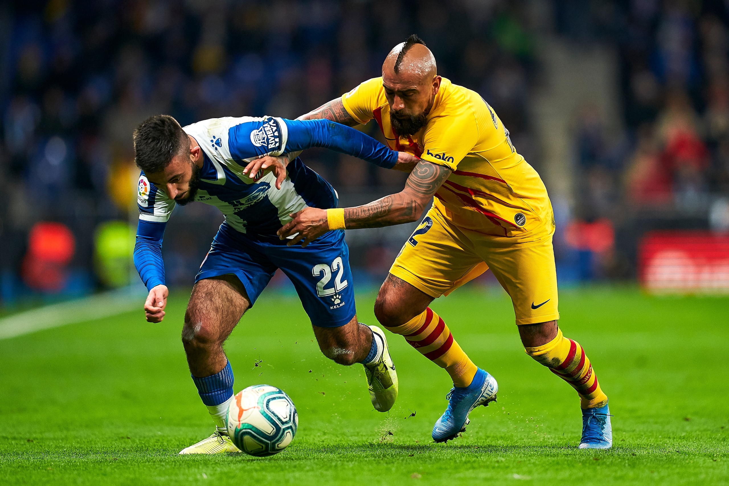 BARCELONA, SPAIN - JANUARY 04: Mario Vargas of RCD Espanyol competes for the ball with Arturo Vidal of FC Barcelona during the Liga match between RCD Espanyol and FC Barcelona at RCDE Stadium on January 04, 2020 in Barcelona, Spain. (Photo by Quality Spor