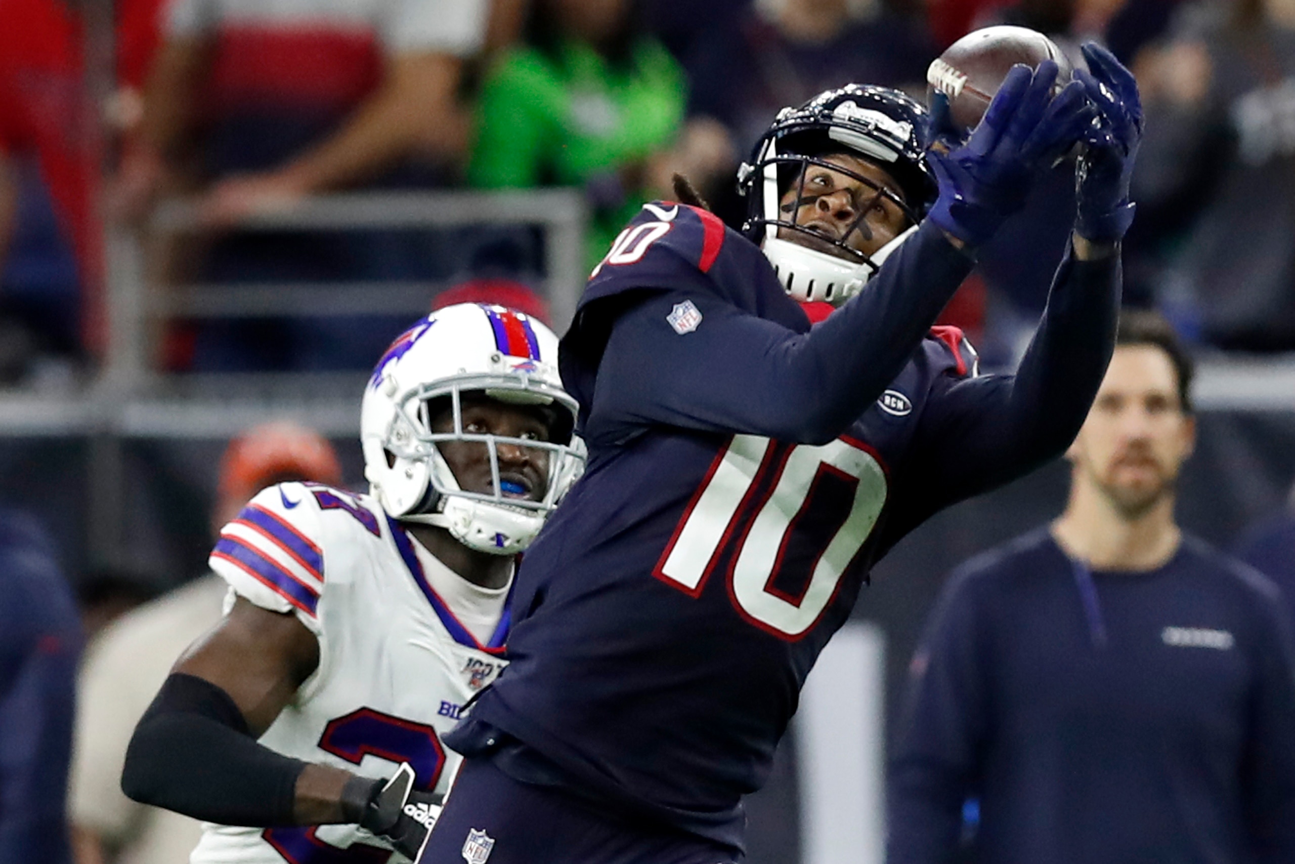 HOUSTON, TEXAS - JANUARY 04: Wide receiver DeAndre Hopkins #10 of the Houston Texans makes a catch over Tre'Davious White #27 of the Buffalo Bills during the AFC Wild Card Playoff game at NRG Stadium on January 04, 2020 in Houston, Texas. (Photo by Tim Wa
