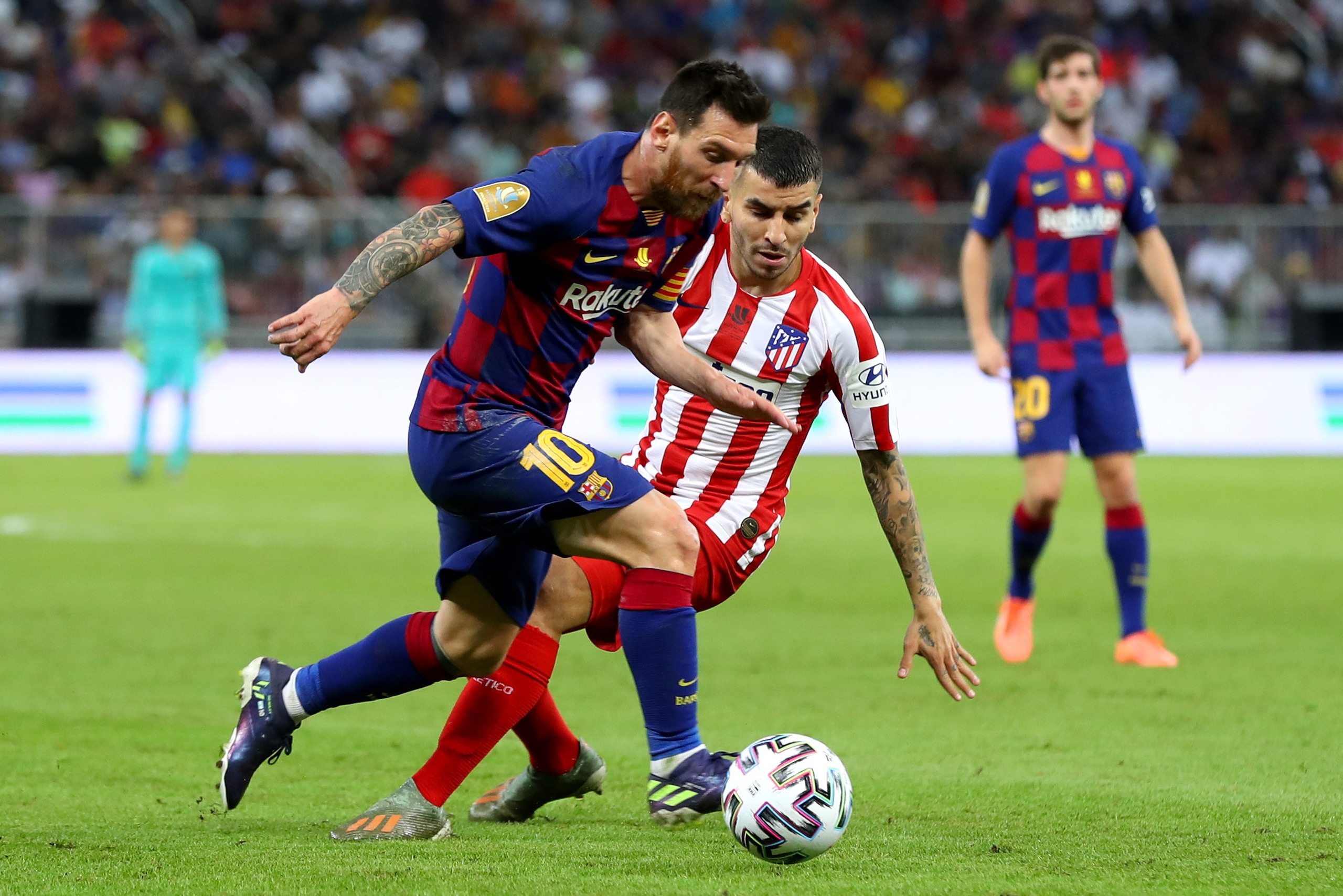JEDDAH, SAUDI ARABIA - JANUARY 09:  Lionel Messi of Barcelona avoids Angel Correa of Athletico Madrid during the Supercopa de Espana Semi-Final match between FC Barcelona and Club Atletico de Madrid at King Abdullah Sports City on January 09, 2020 in Jedd
