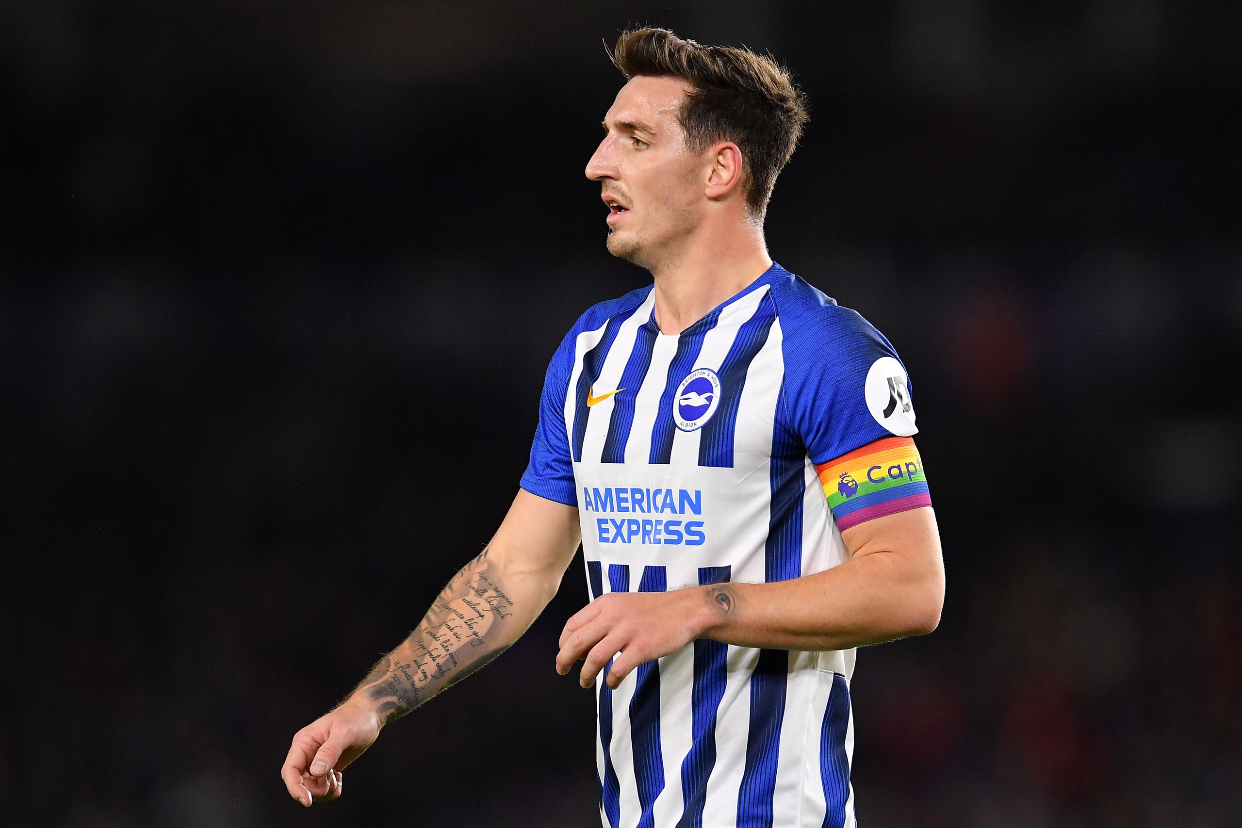 BRIGHTON, ENGLAND - DECEMBER 08: Lewis Dunk of Brighton & Hove Albion wears the stonewall rainbow laces captains armband during the Premier League match between Brighton & Hove Albion and Wolverhampton Wanderers at American Express Community Stadium on De