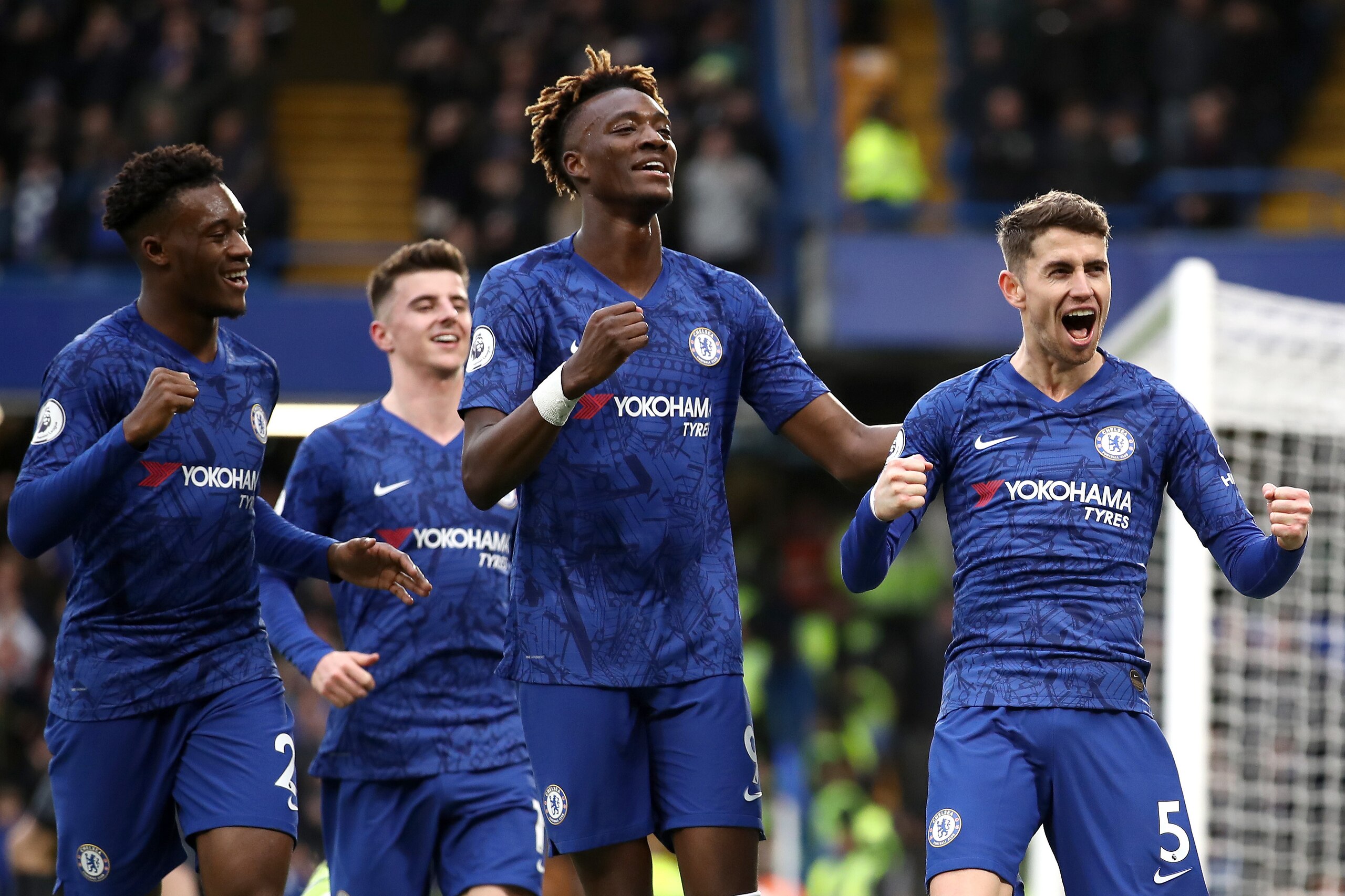 LONDON, ENGLAND - JANUARY 11: Jorginho of Chelsea celebrates with teammates Callum Hudson-Odoi and Tammy Abraham after scoring his team's first goal during the Premier League match between Chelsea FC and Burnley FC at Stamford Bridge on January 11, 2020 i
