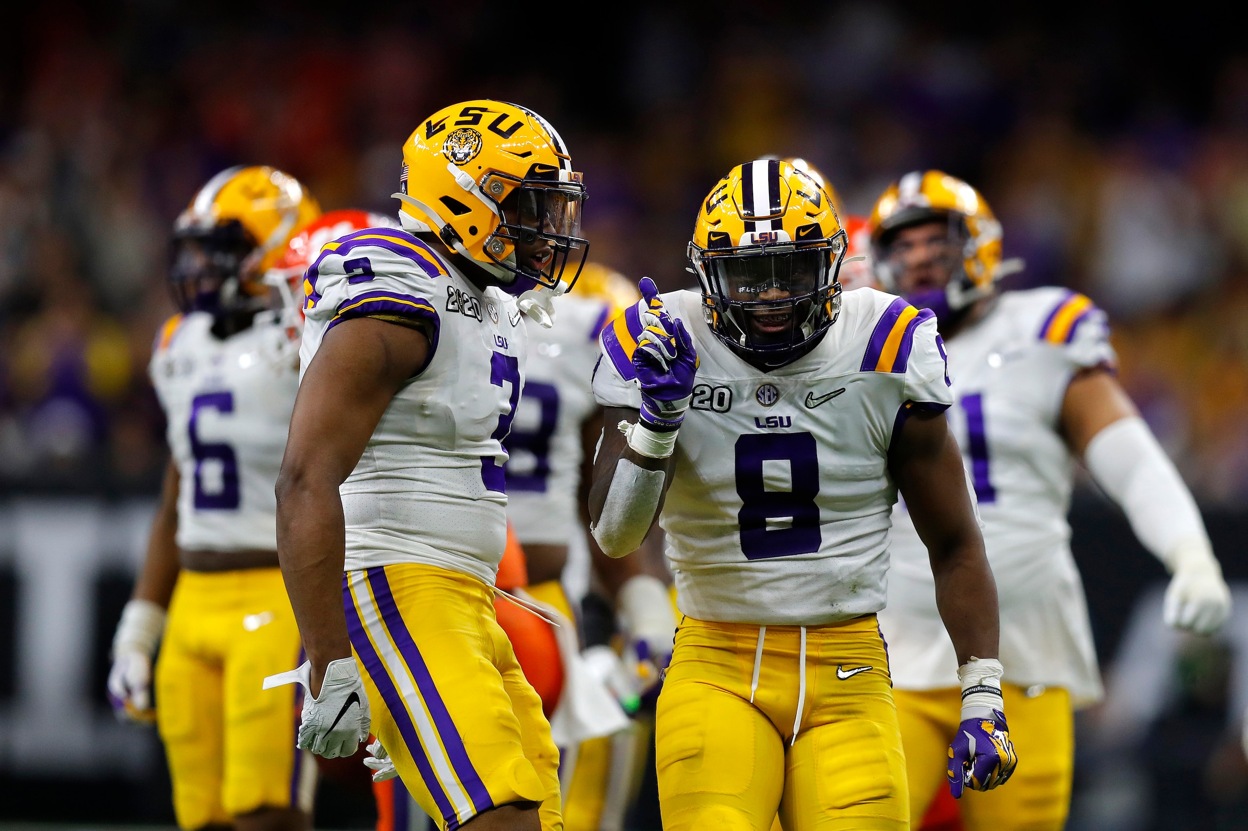 NEW ORLEANS, LOUISIANA - JANUARY 13: Patrick Queen #8 of the LSU Tigers celebrates a huge defensive stop against Clemson Tigers in the College Football Playoff National Championship game at Mercedes Benz Superdome on January 13, 2020 in New Orleans, Louis