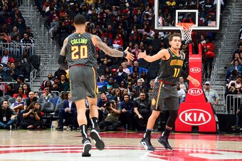 ATLANTA, GA - JANUARY 14: John Collins #20, and Trae Young #11 of the Atlanta Hawks hi-five each other during the game against the Phoenix Suns on January 14, 2020 at State Farm Arena in Atlanta, Georgia.  NOTE TO USER: User expressly acknowledges and agr