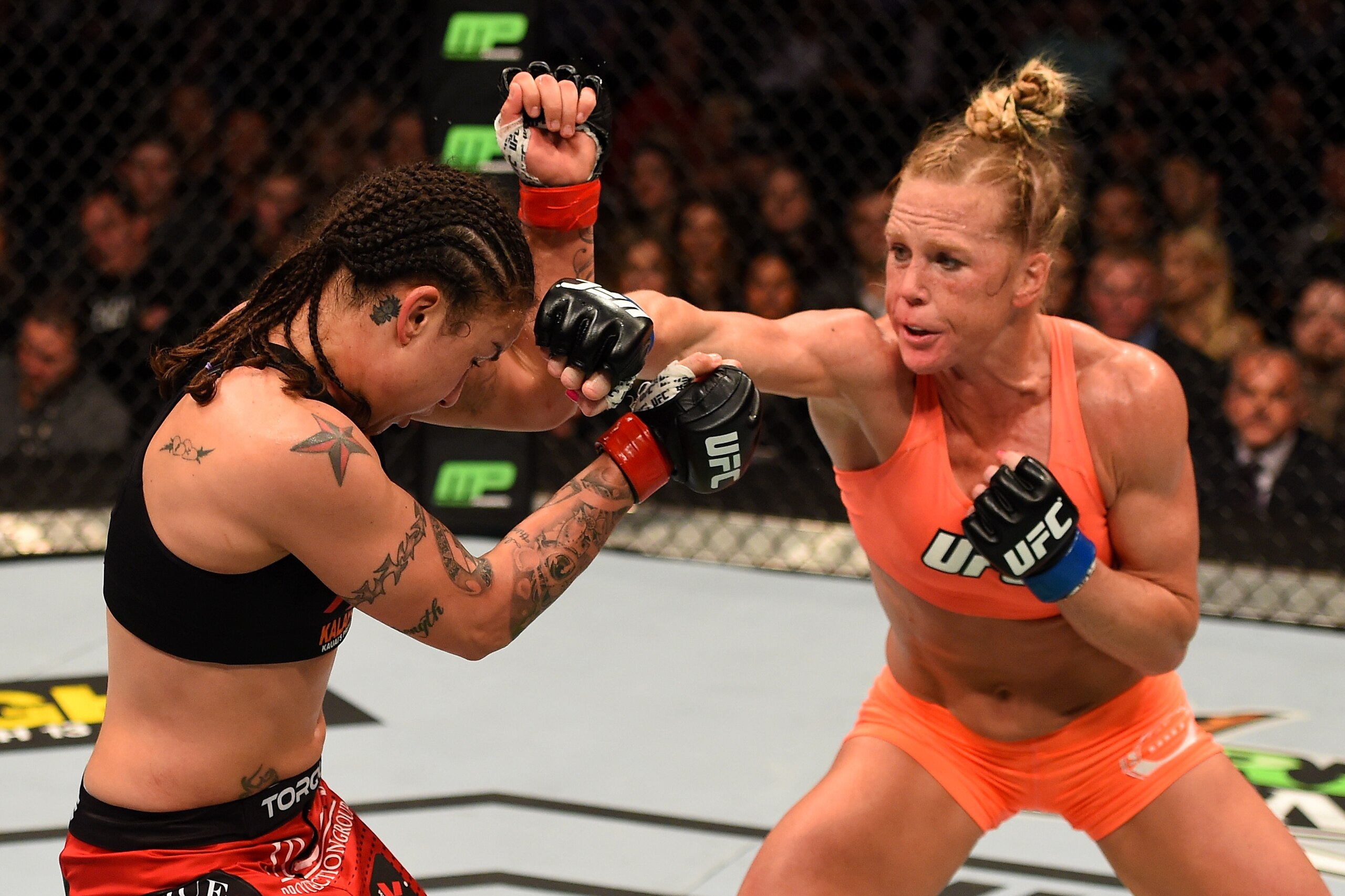 LOS ANGELES, CA - FEBRUARY 28:  (R) Holly Holm punches Raquel Pennington in their women's bantamweight bout during the UFC 184 event at Staples Center on February 28, 2015 in Los Angeles, California.  (Photo by Josh Hedges/Zuffa LLC/Zuffa LLC via Getty Im