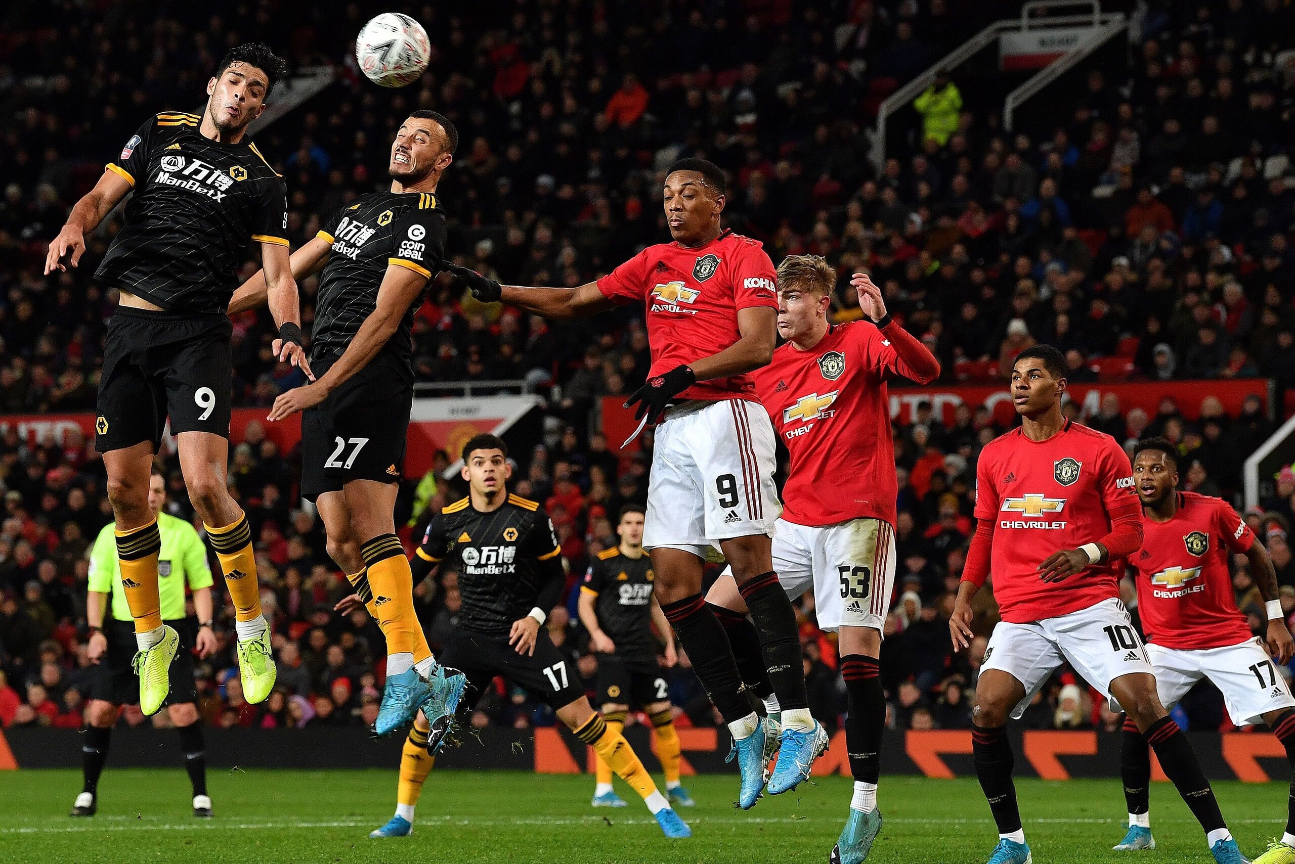 Wolverhampton Wanderers' Mexican striker Raul Jimenez (L) headers the ball but fails to score during the English FA Cup third round-replay football match between Manchester United and Wolverhampton Wanderers at Old Trafford in Manchester, north west Engla