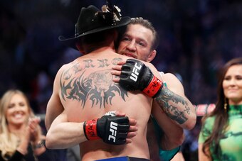 McGregor and Donald Cerrone (foreground) embrace post-fight