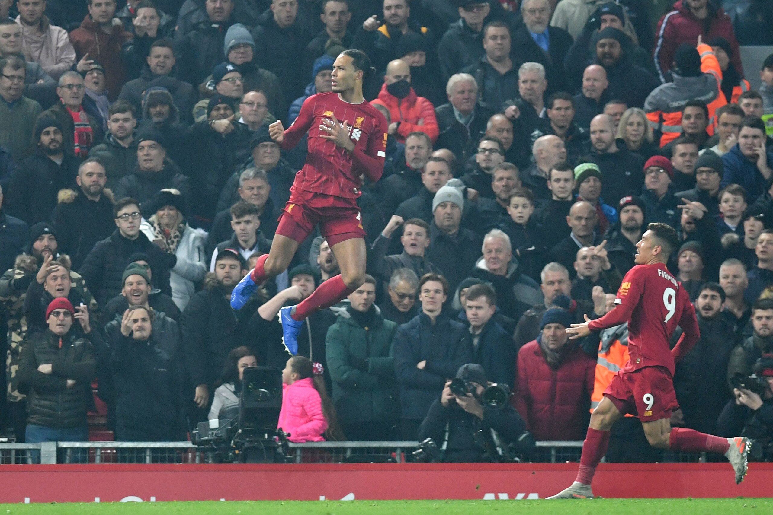Liverpool's Dutch defender Virgil van Dijk (L) celebrates scoring the opening goal during the English Premier League football match between Liverpool and Manchester United at Anfield stadium in Liverpool, north west England on January 19, 2020. (Photo by 