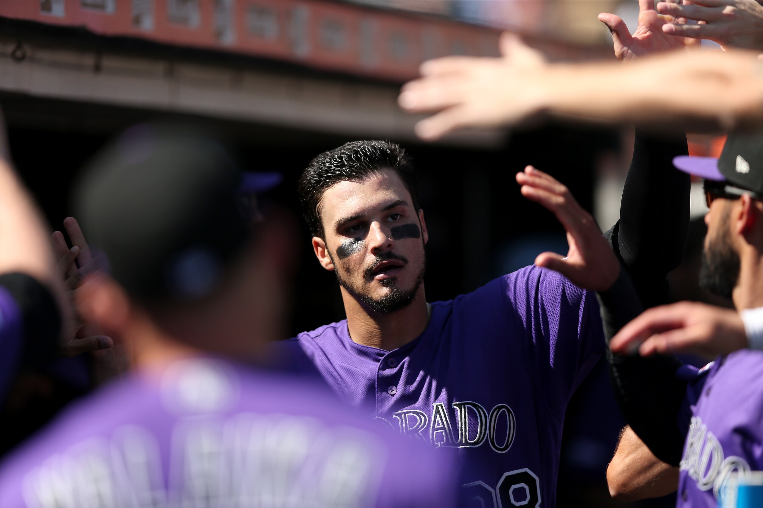 SAN FRANCISCO, CALIFORNIA - SEPTEMBER 26:  Nolan Arenado #28 of the Colorado Rockies is congratulated by players after he scored in the fourth inning against the San Francisco Giants at Oracle Park on September 26, 2019 in San Francisco, California. (Phot