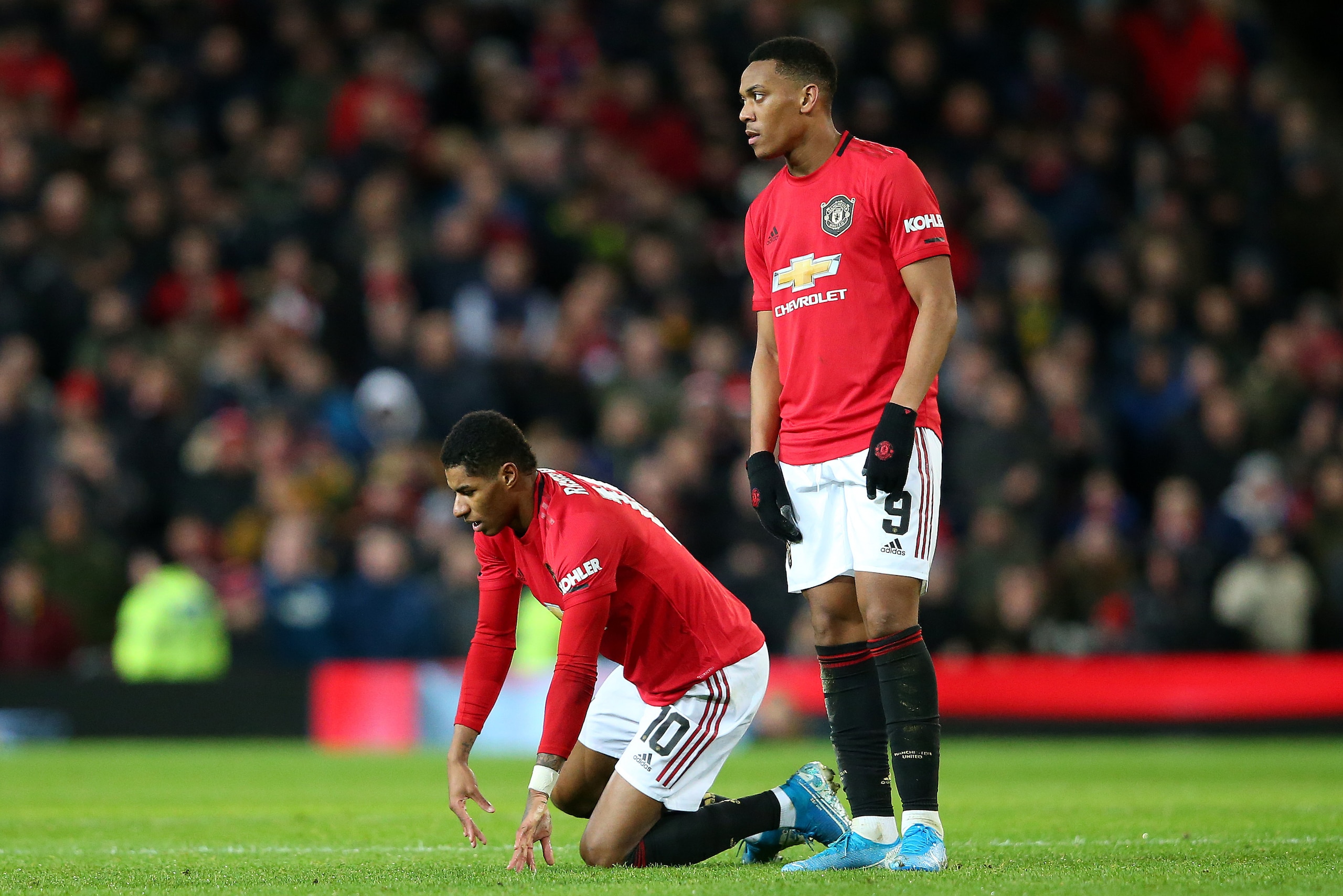 MANCHESTER, ENGLAND - JANUARY 15:  Anthony Martial consoles the injured Marcus Rashford of Manchester United during the FA Cup Third Round Replay match between Manchester United and Wolverhampton Wanderers at Old Trafford on January 15, 2020 in Manchester