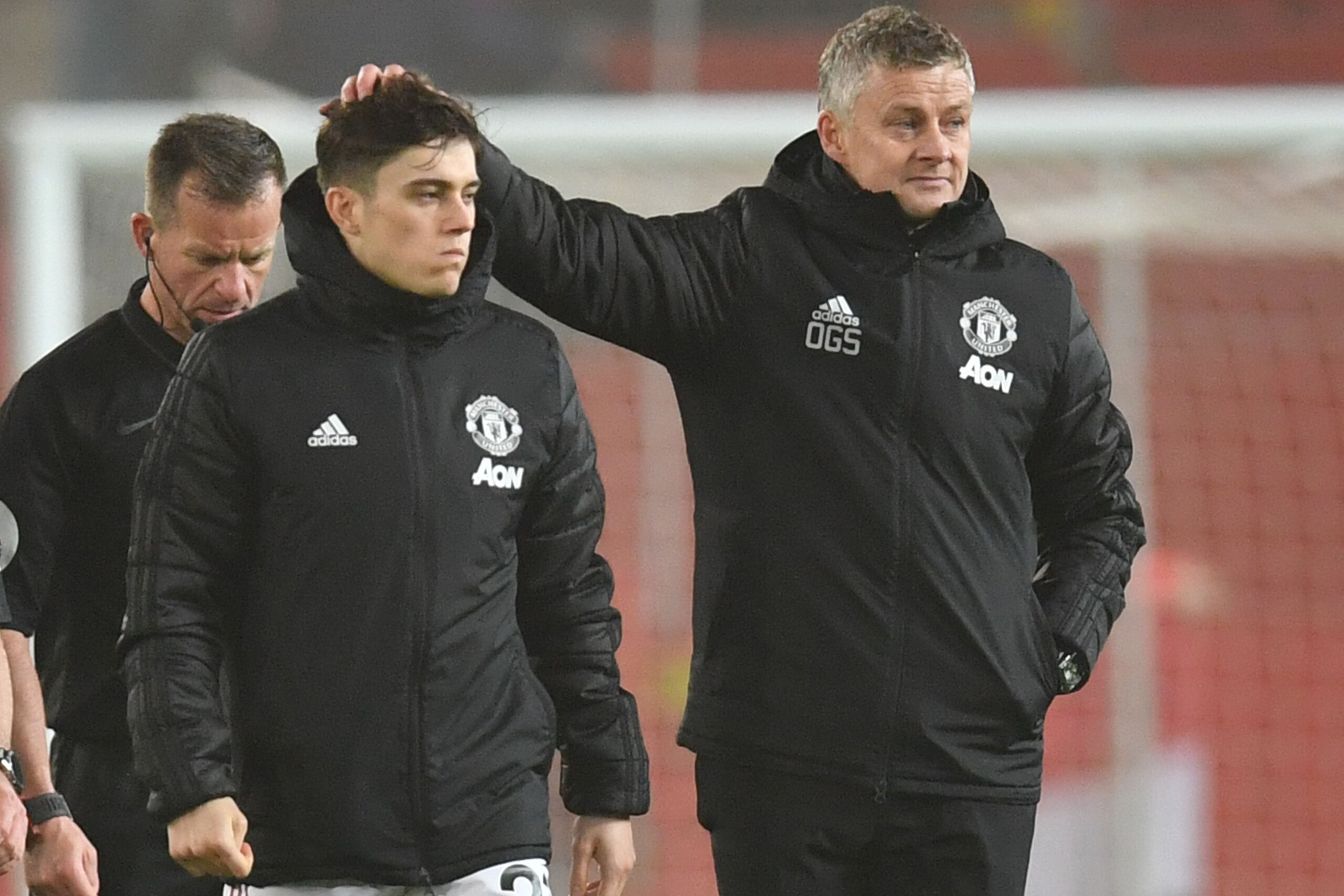 Manchester United's Norwegian manager Ole Gunnar Solskjaer consoles his player after losing the English Premier League football match between Manchester United and Burnley at Old Trafford in Manchester, north west England, on January 22, 2020. - Burnley w