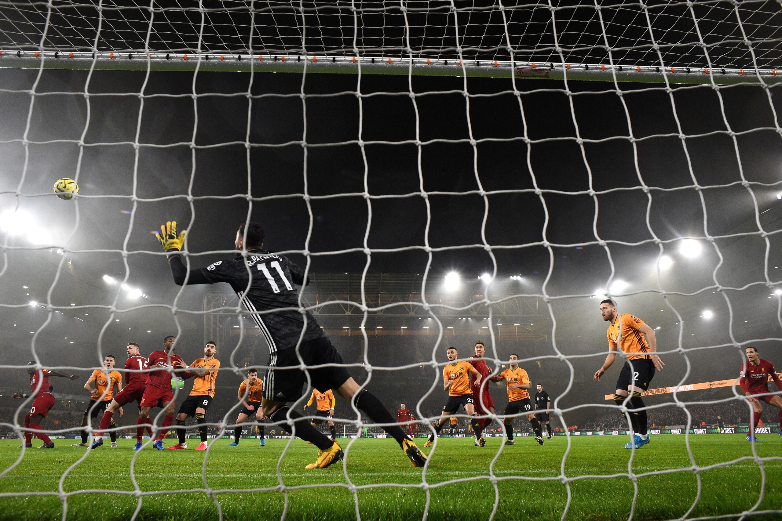 Liverpool's English midfielder Jordan Henderson scores the team's first goal during the English Premier League football match between Wolverhampton Wanderers and Liverpool at the Molineux stadium in Wolverhampton, central England on January 23, 2020. (Pho