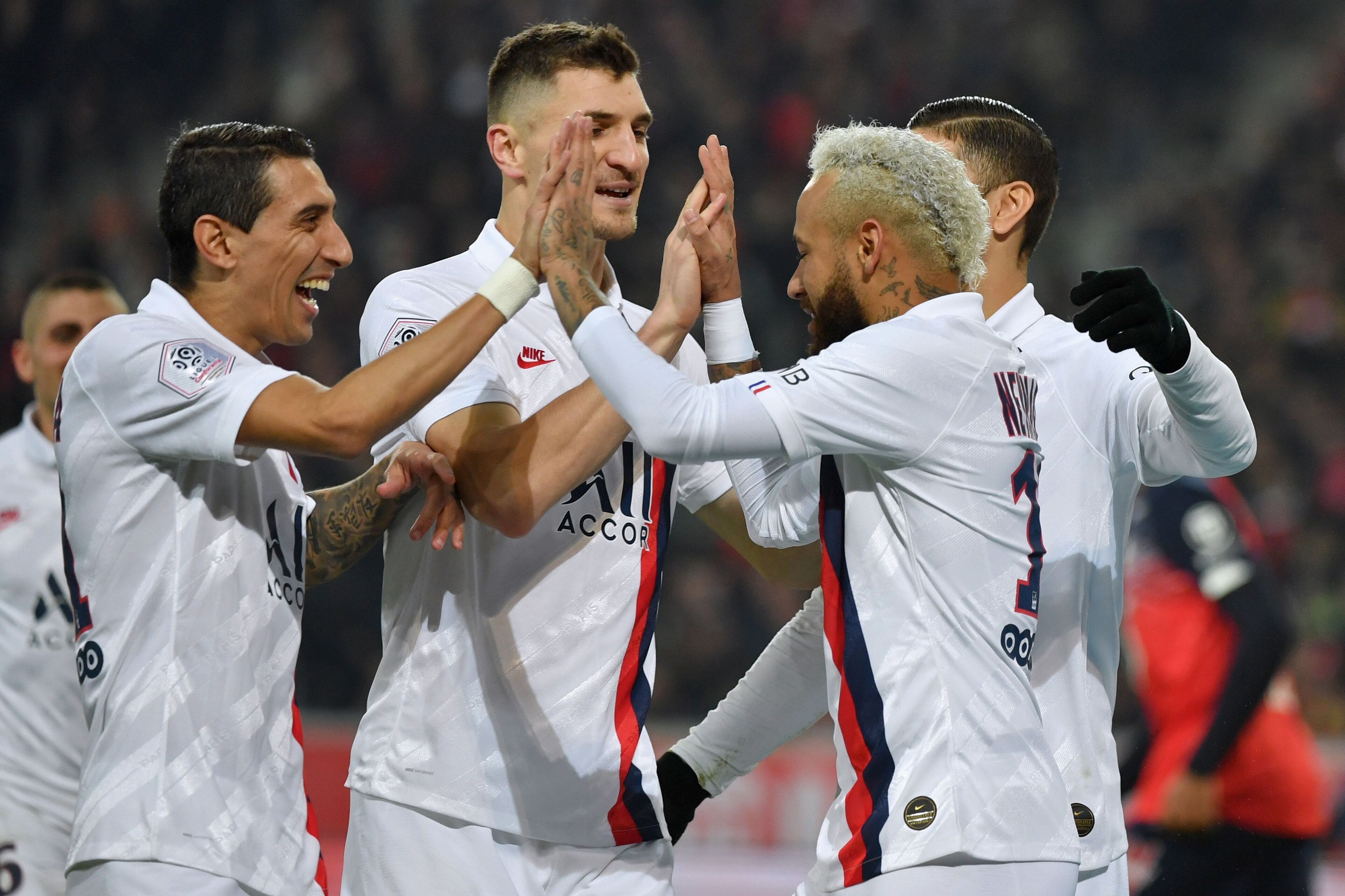 Paris Saint-Germain's Brazilian forward Neymar (R) celebrates with Paris Saint-Germain's Argentine midfielder Angel Di Maria (L) and teammates after scoring his second goal during the French L1 football match between Lille (LOSC) and Paris Saint-Germain (
