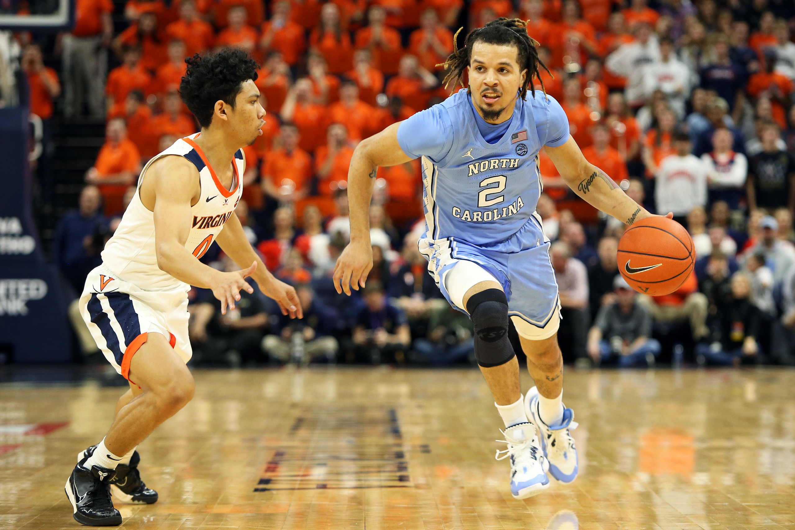 CHARLOTTESVILLE, VA - DECEMBER 07: Cole Anthony #2 of the North Carolina Tar Heels drives past Kihei Clark #0 of the Virginia Cavaliers in the first half during a game at John Paul Jones Arena on December 7, 2019 in Charlottesville, Virginia. (Photo by Ry