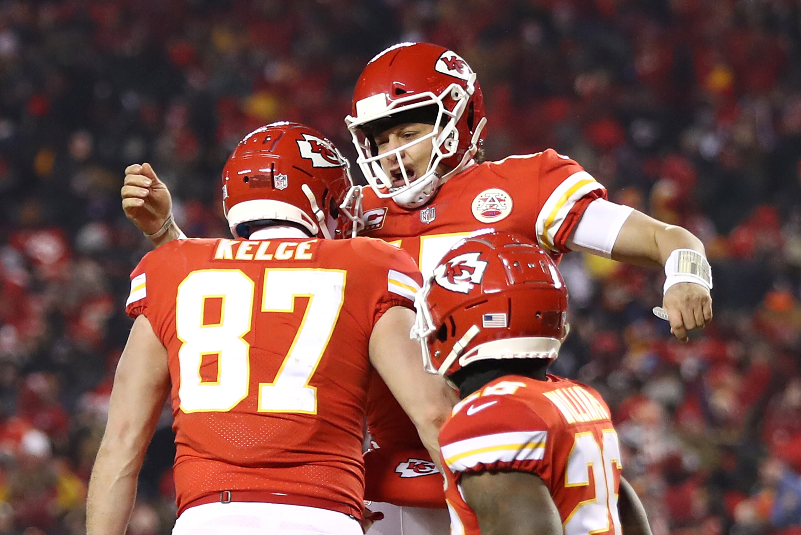 KANSAS CITY, MISSOURI - JANUARY 20: Patrick Mahomes #15 of the Kansas City Chiefs celebrates with Travis Kelce #87 after scoring a touchdown in the third quarter against the New England Patriots during the AFC Championship Game at Arrowhead Stadium on Jan