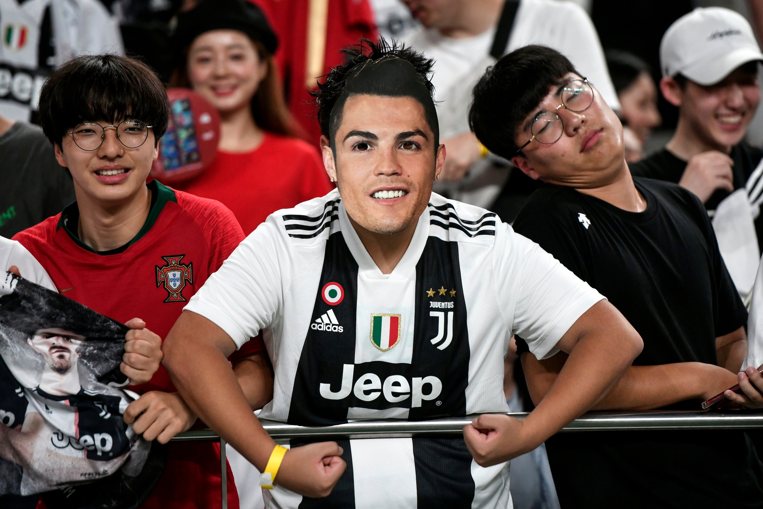 A South Korean football fan wears a mask of Juventus FC's Cristiano Ronaldo prior to a friendly football match between Team K League and Juventus FC in Seoul on July 26, 2019. - Juventus tied 3-3 in a friendly with K League All-Star team in Seoul on July 