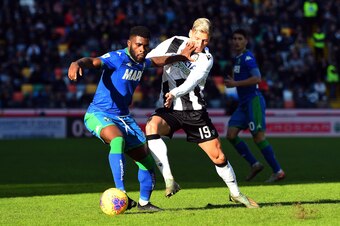 UDINE, ITALY - JANUARY 12: Jeremie Boga of US Sassuolo competes for the ball with Jens Stryger Larsen of Udinese Calcio during the Serie A match between Udinese Calcio and US Sassuolo at Stadio Friuli on January 12, 2020 in Udine, Italy.  (Photo by Alessa