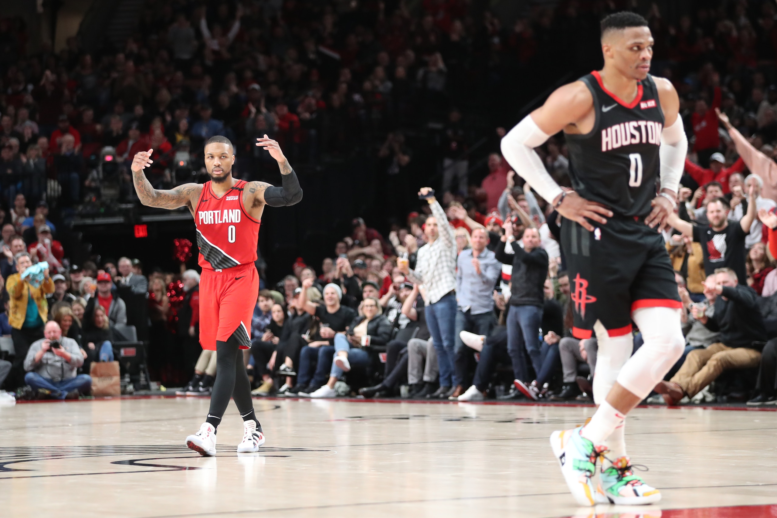 PORTLAND, OREGON - JANUARY 29: Damian Lillard #0 of the Portland Trail Blazers hypes up the crowd alongside Russell Westbrook #0 of the Houston Rockets in the fourth quarter during their game at Moda Center on January 29, 2020 in Portland, Oregon. NOTE TO