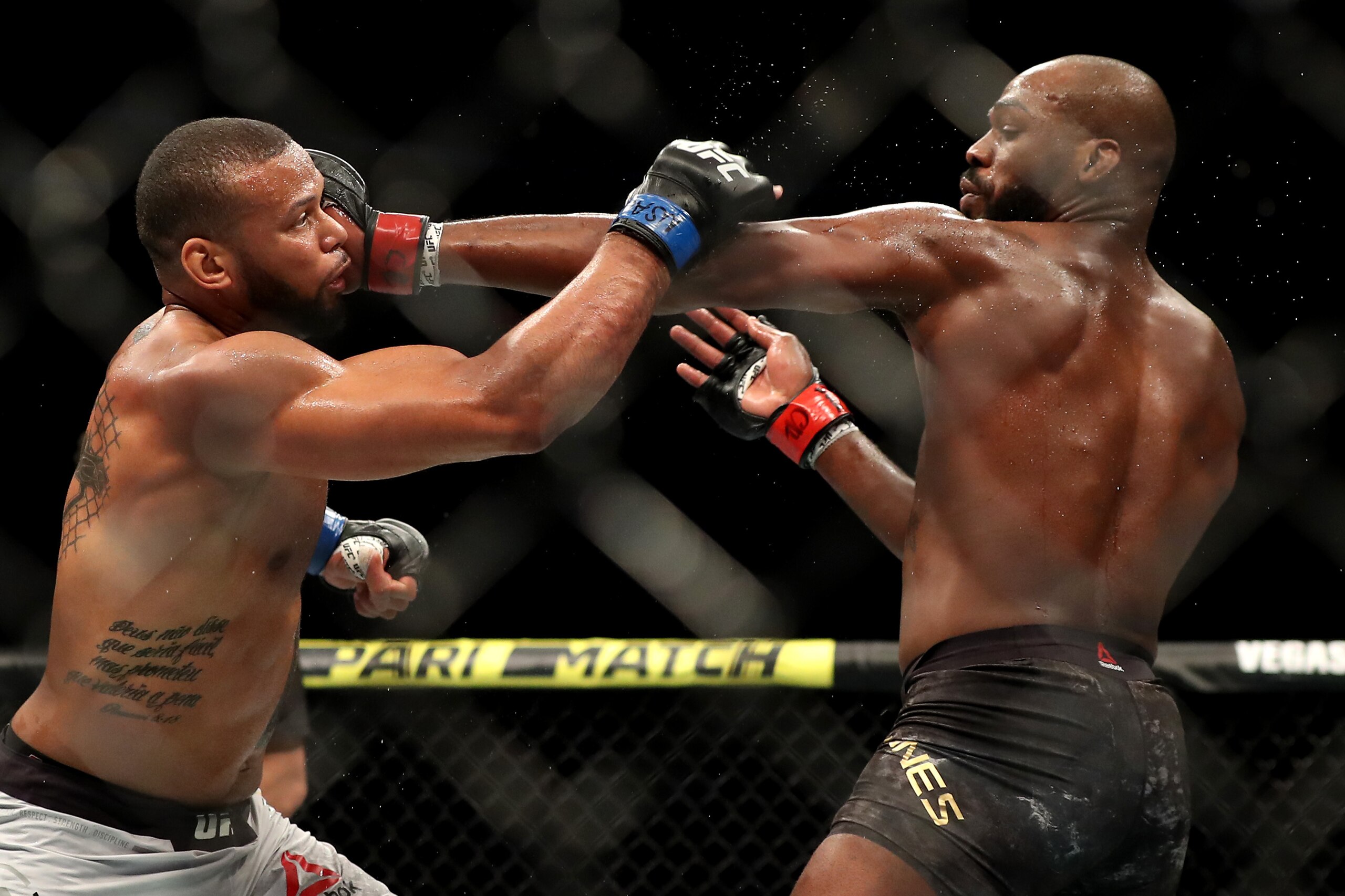 LAS VEGAS, NEVADA - JULY 06:  Jon Jones of the United States punches Thiago Santos of Brazil during their UFC Light Heavyweight Title bout at T-Mobile Arena on July 06, 2019 in Las Vegas, Nevada. (Photo by Sean M. Haffey/Getty Images)