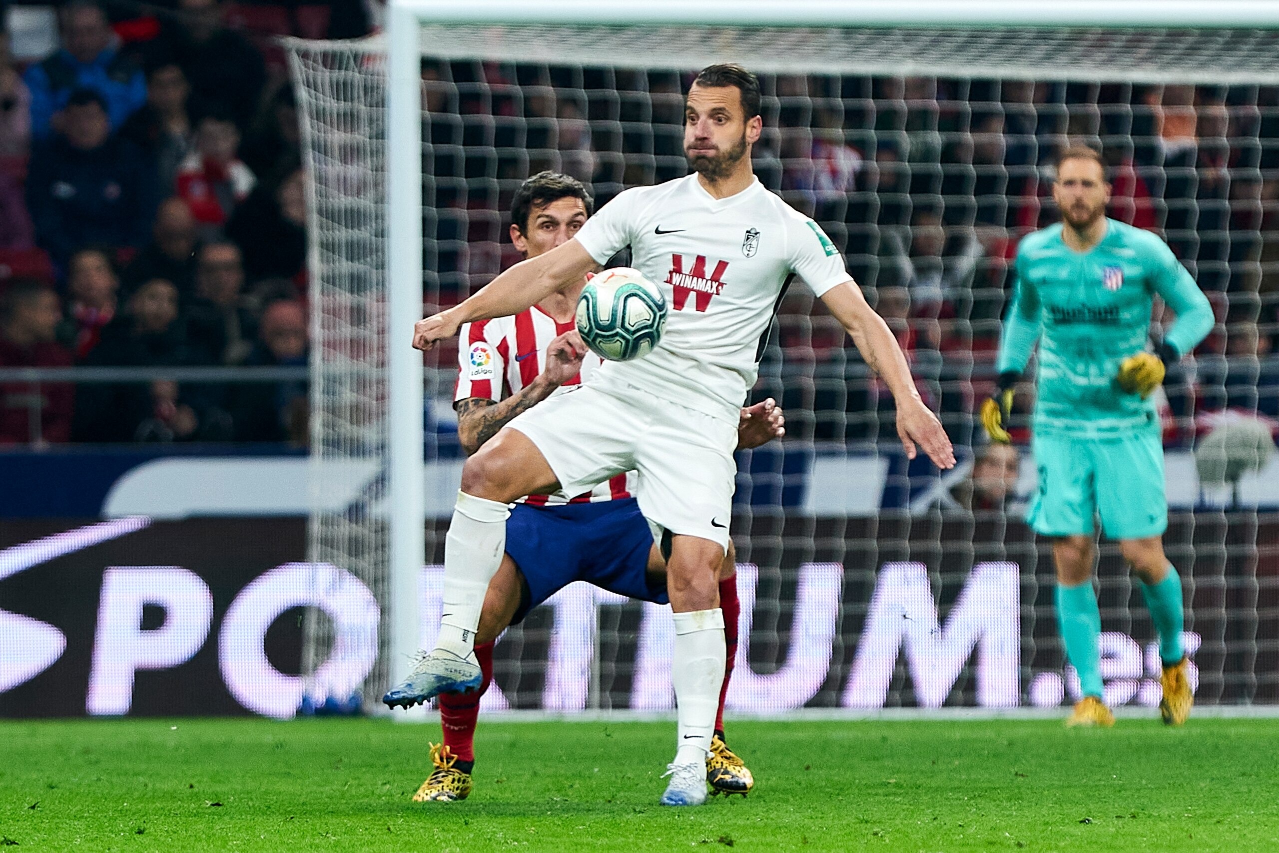 MADRID, SPAIN - FEBRUARY 08: Stefan Savic of Atletico de Madrid and Roberto Soldado of Granada CF during the Liga match between Club Atletico de Madrid and Granada CF at Wanda Metropolitano on February 8, 2020 in Madrid, Spain. (Photo by Perez Meca/MB Med
