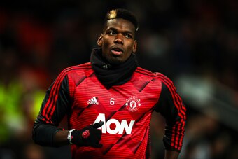 MANCHESTER, ENGLAND - DECEMBER 26: Paul Pogba of Manchester United wearing his personalised wrist bands against racism during the Premier League match between Manchester United and Newcastle United at Old Trafford on December 26, 2019 in Manchester, Unite