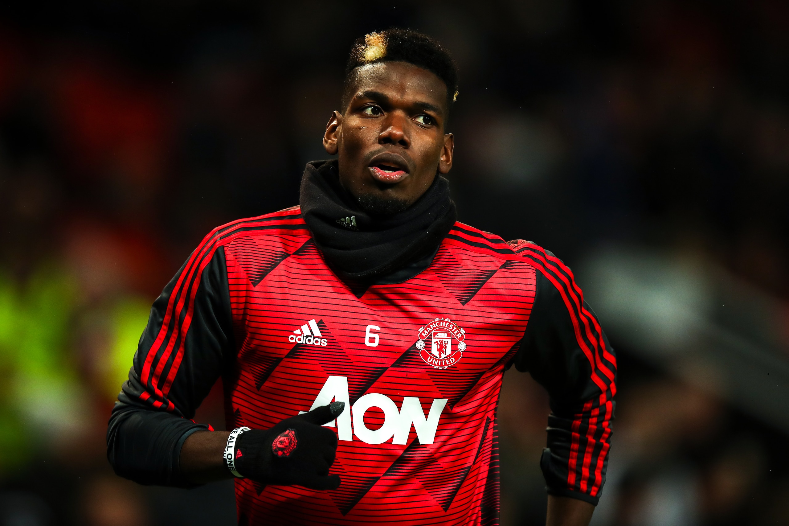 MANCHESTER, ENGLAND - DECEMBER 26: Paul Pogba of Manchester United wearing his personalised wrist bands against racism during the Premier League match between Manchester United and Newcastle United at Old Trafford on December 26, 2019 in Manchester, Unite