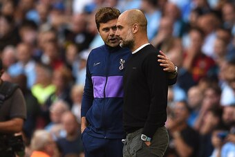 Tottenham Hotspur's Argentinian head coach Mauricio Pochettino (L) and Manchester City's Spanish manager Pep Guardiola talk after the VAR decision ruled out what would have benn Manchester's City's thrid goal during the English Premier League football mat