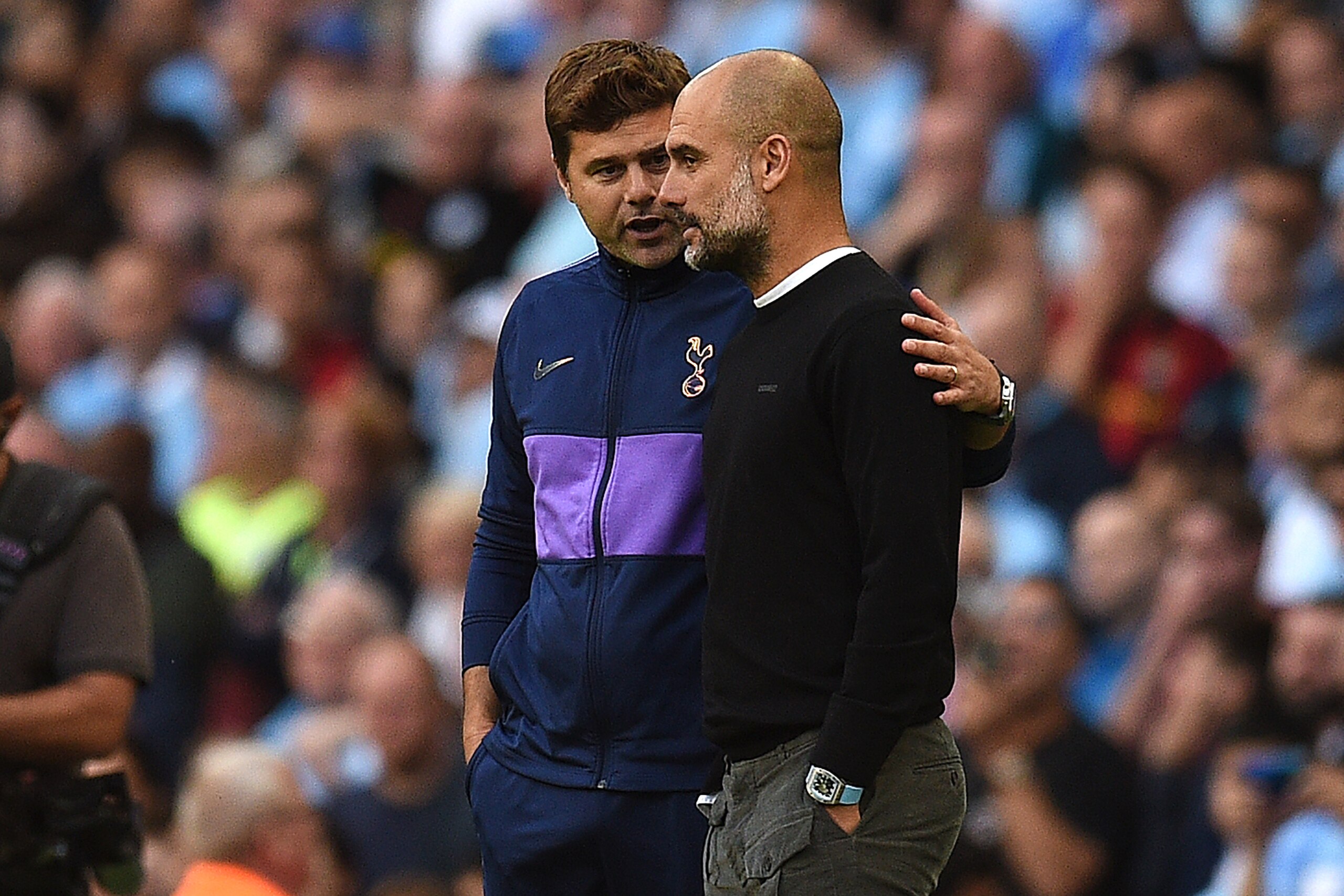 Tottenham Hotspur's Argentinian head coach Mauricio Pochettino (L) and Manchester City's Spanish manager Pep Guardiola talk after the VAR decision ruled out what would have benn Manchester's City's thrid goal during the English Premier League football mat