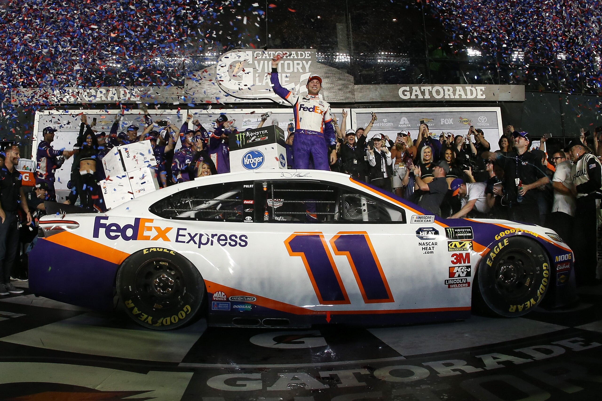 DAYTONA BEACH, FL - FEBRUARY 17:  Denny Hamlin, driver of the #11 FedEx Express Toyota, celebrates in victory lane after winning the Monster Energy NASCAR Cup Series 61st Annual Daytona 500 at Daytona International Speedway on February 17, 2019 in Daytona